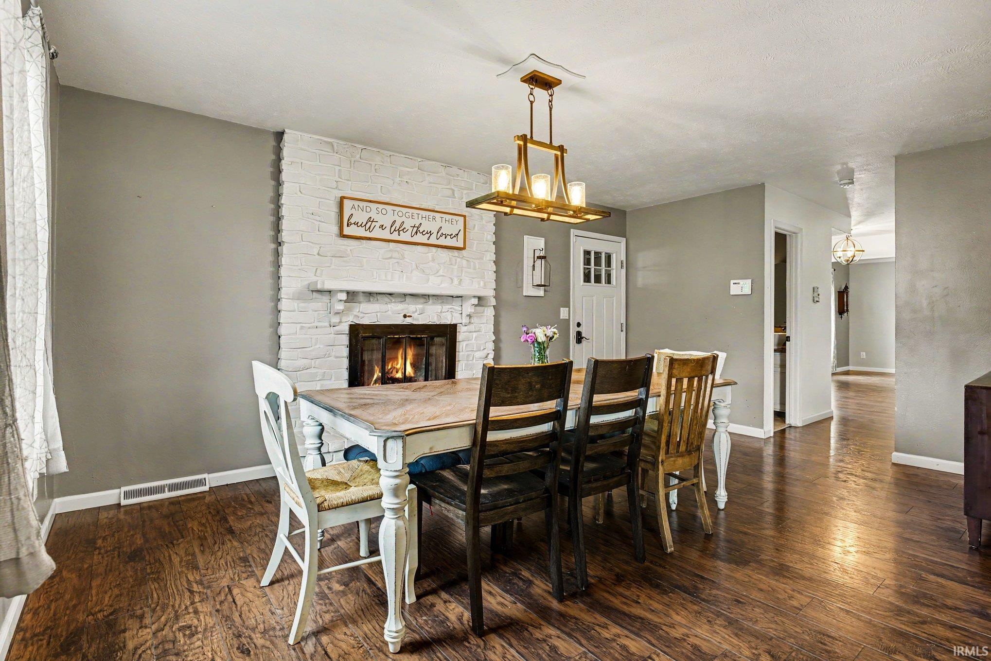 Brick fireplace with a painted white finish and mantel
