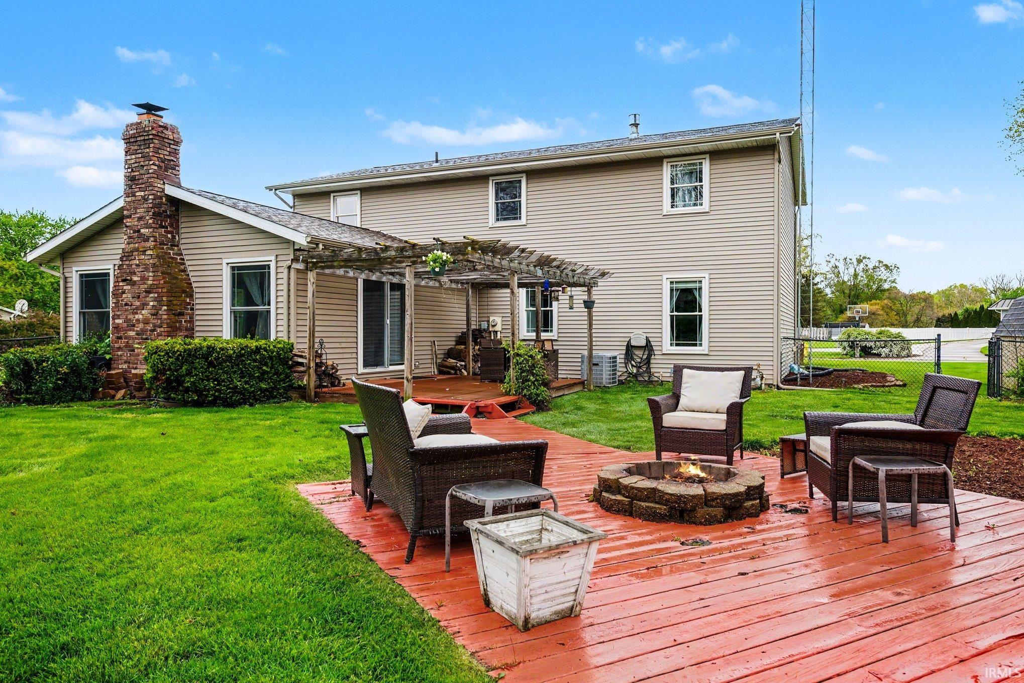 Expansive wood deck with a built-in stone fire pit