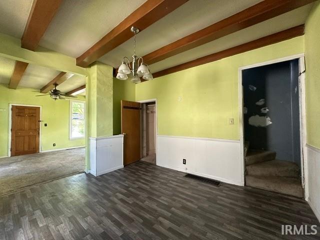 Interior space featuring exposed wood-finish ceiling beams, a chandelier, and wood-finish flooring