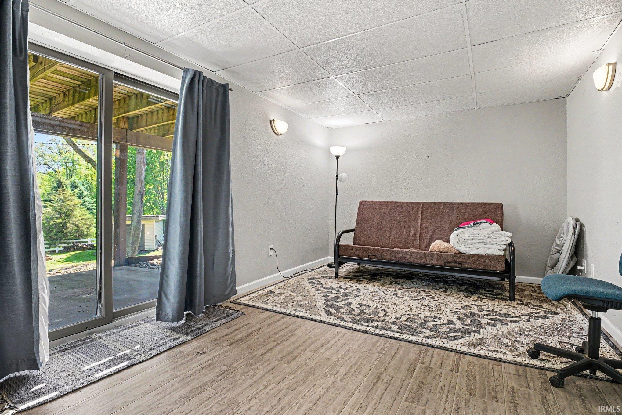 Light-colored wood-finish flooring complements the neutral wall color