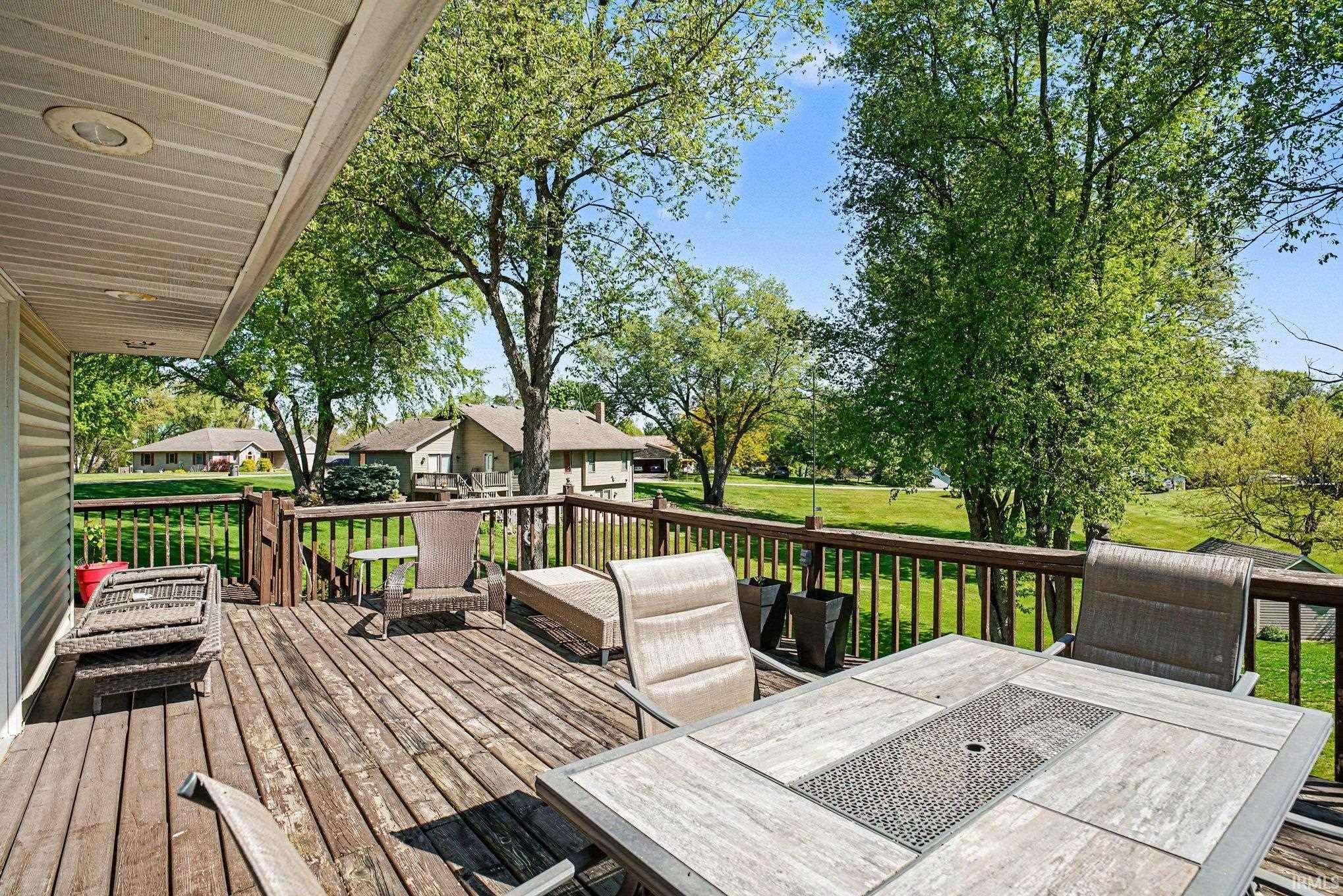 Expansive wood deck with a full-height railing system, offering an open-air extension of the home