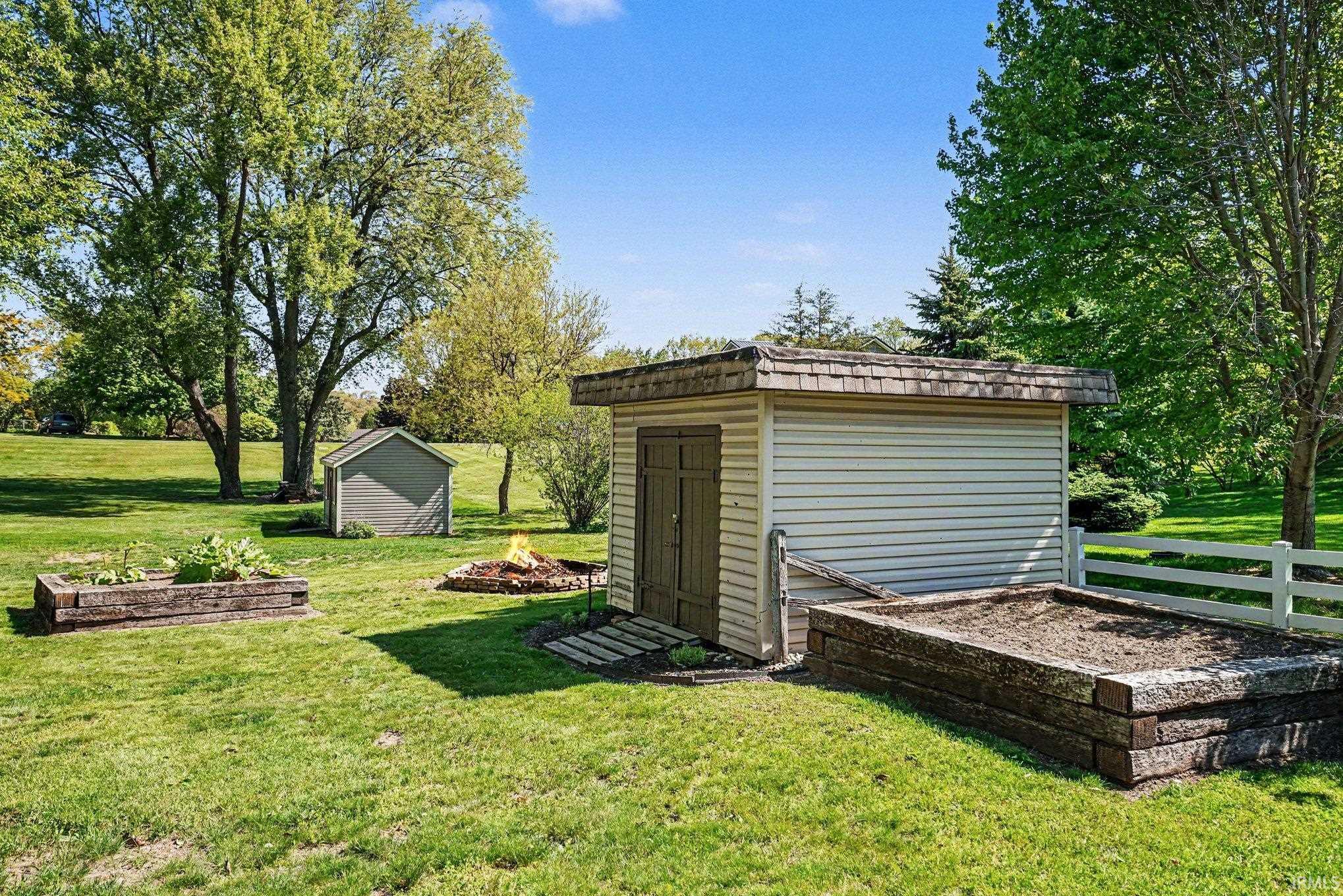 Detached utility shed with horizontal siding and a shingle roof