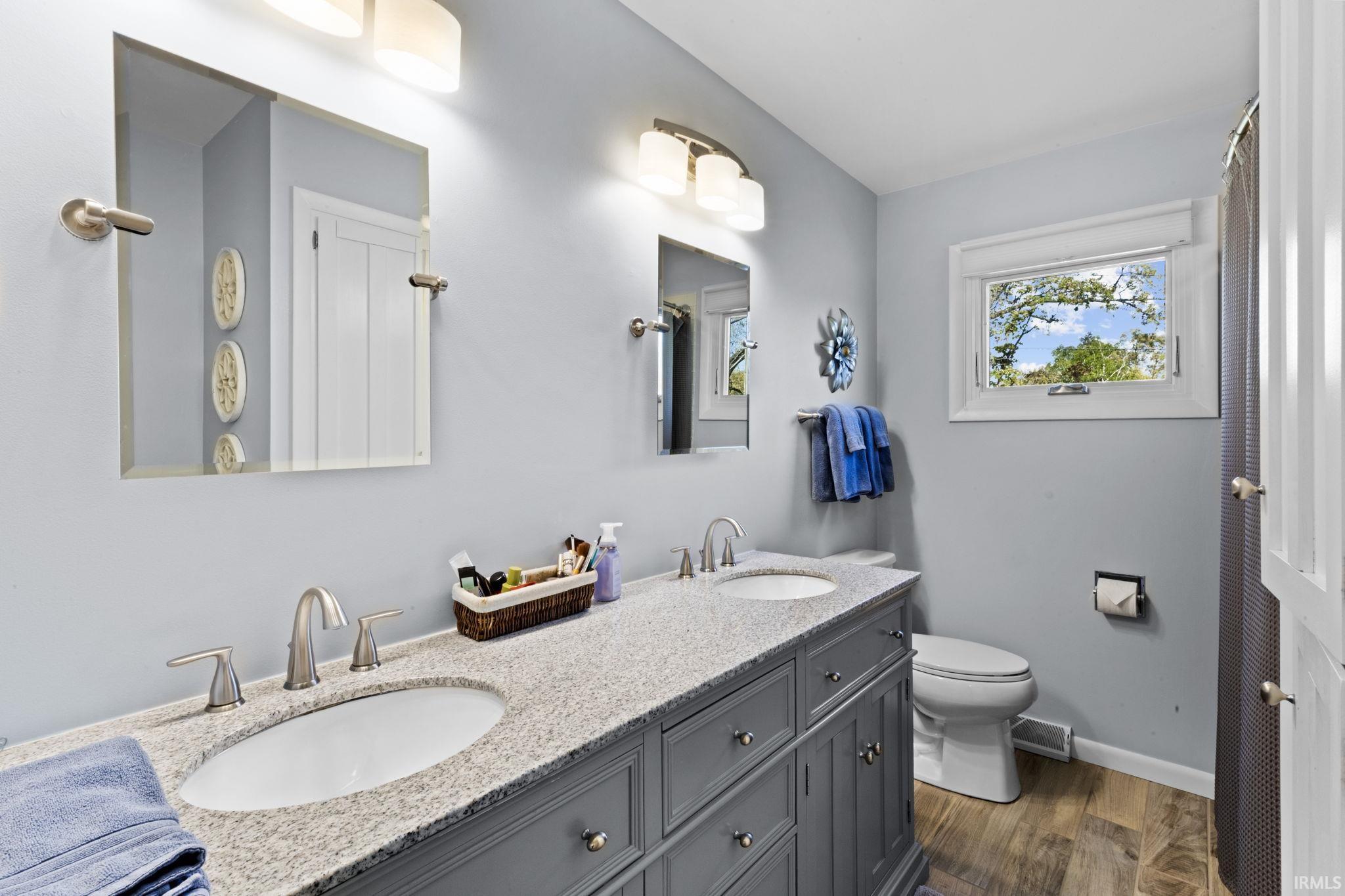Double vanity with granite-style countertop and dual undermount sinks