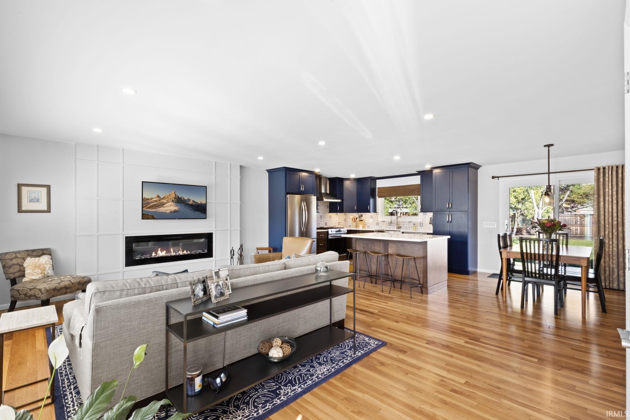 Open-concept living space featuring wood-finish flooring throughout