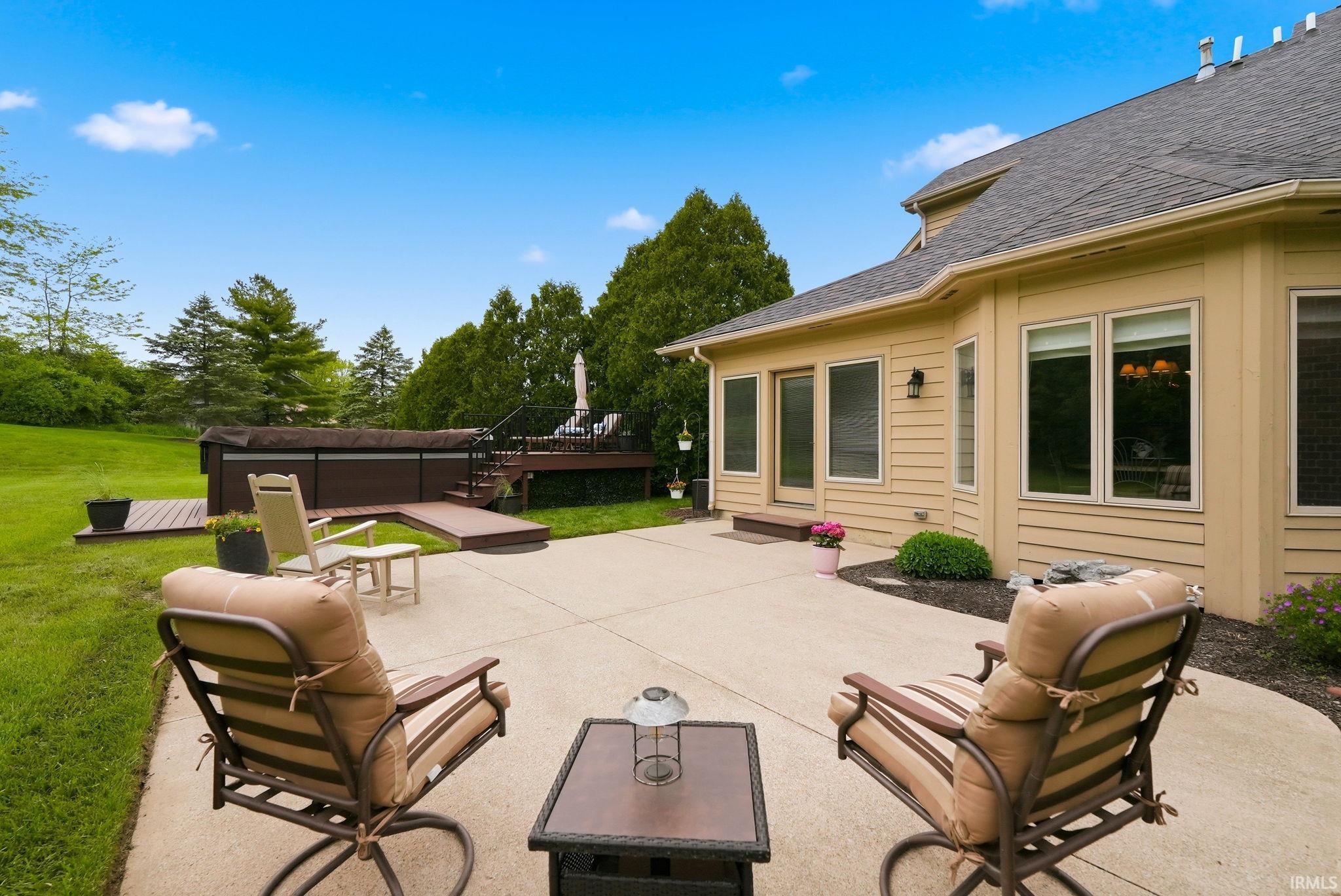 Expansive concrete patio offering direct access to the home