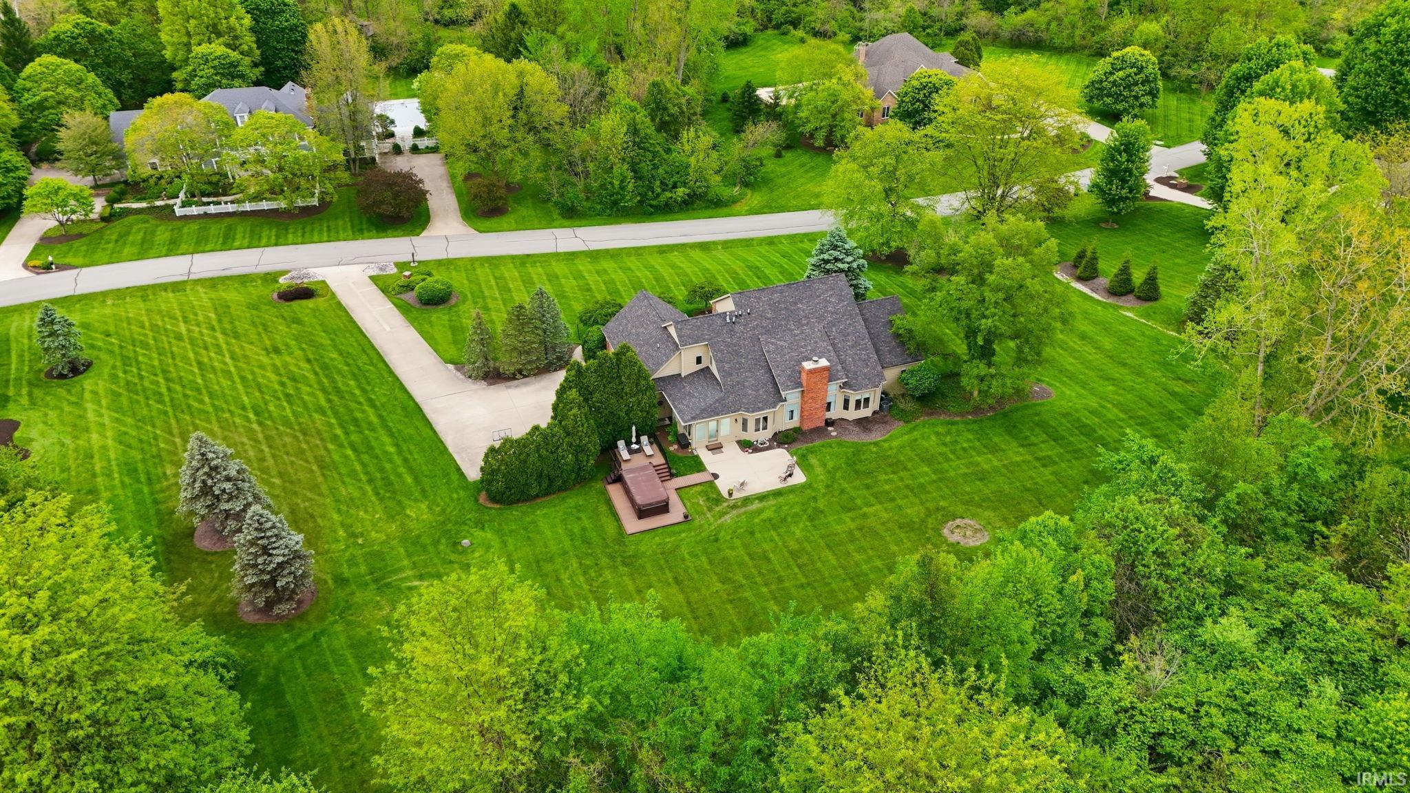 Expansive property featuring a large residence with a multi-gabled roof and a prominent brick chimney