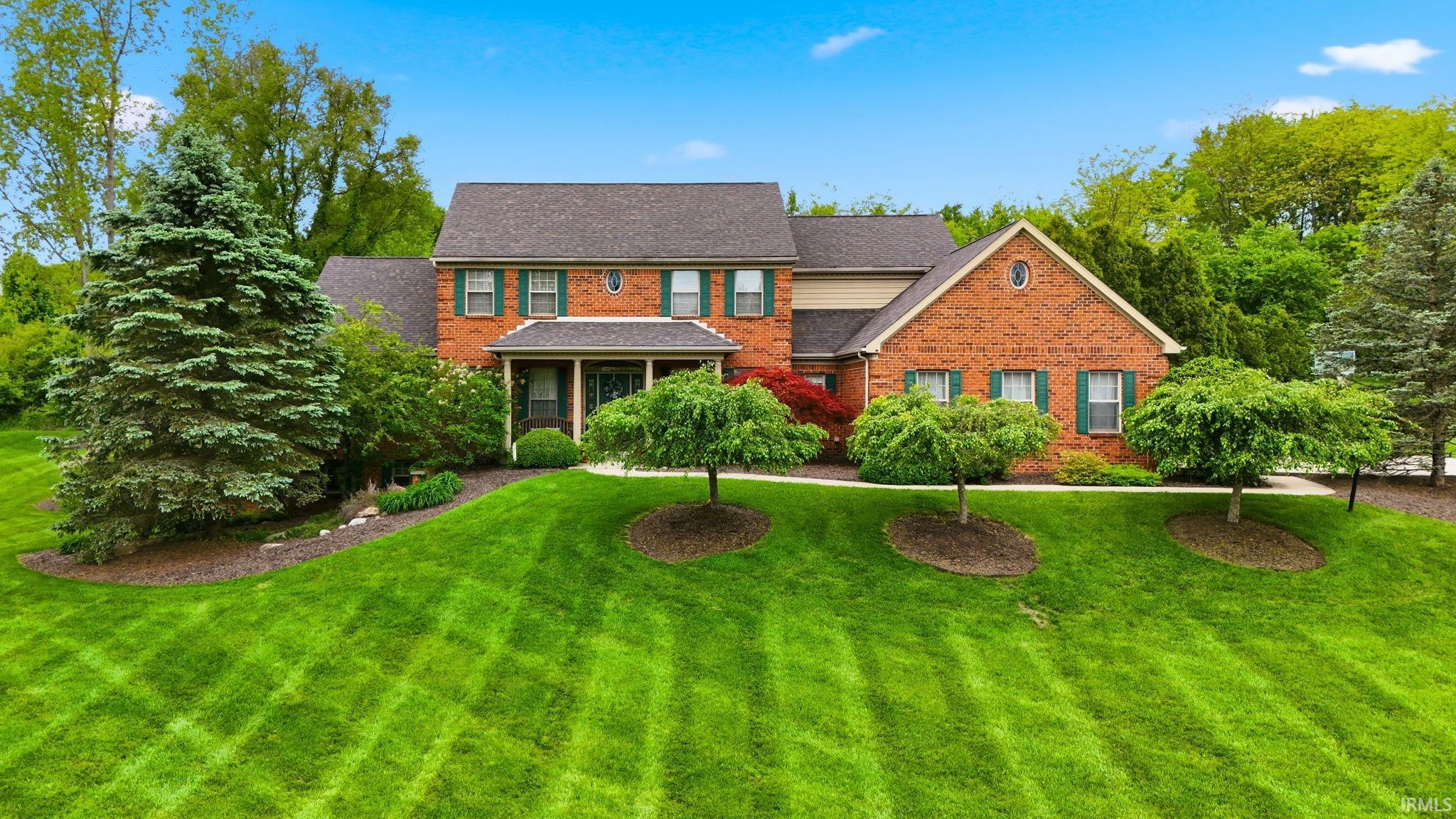 Brick facade residence featuring a covered front entry!