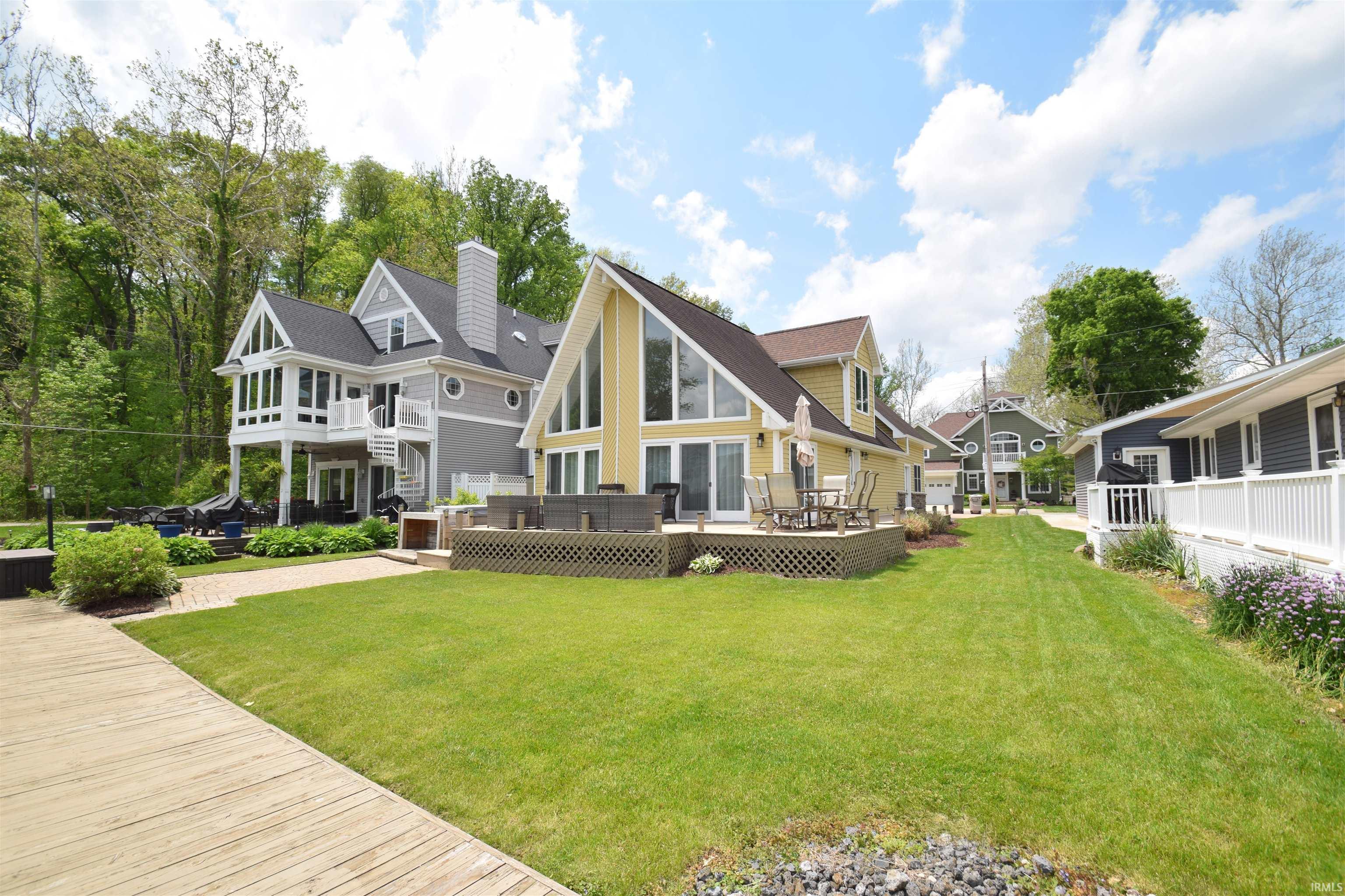 Expansive green lawn with a wooden walkway
