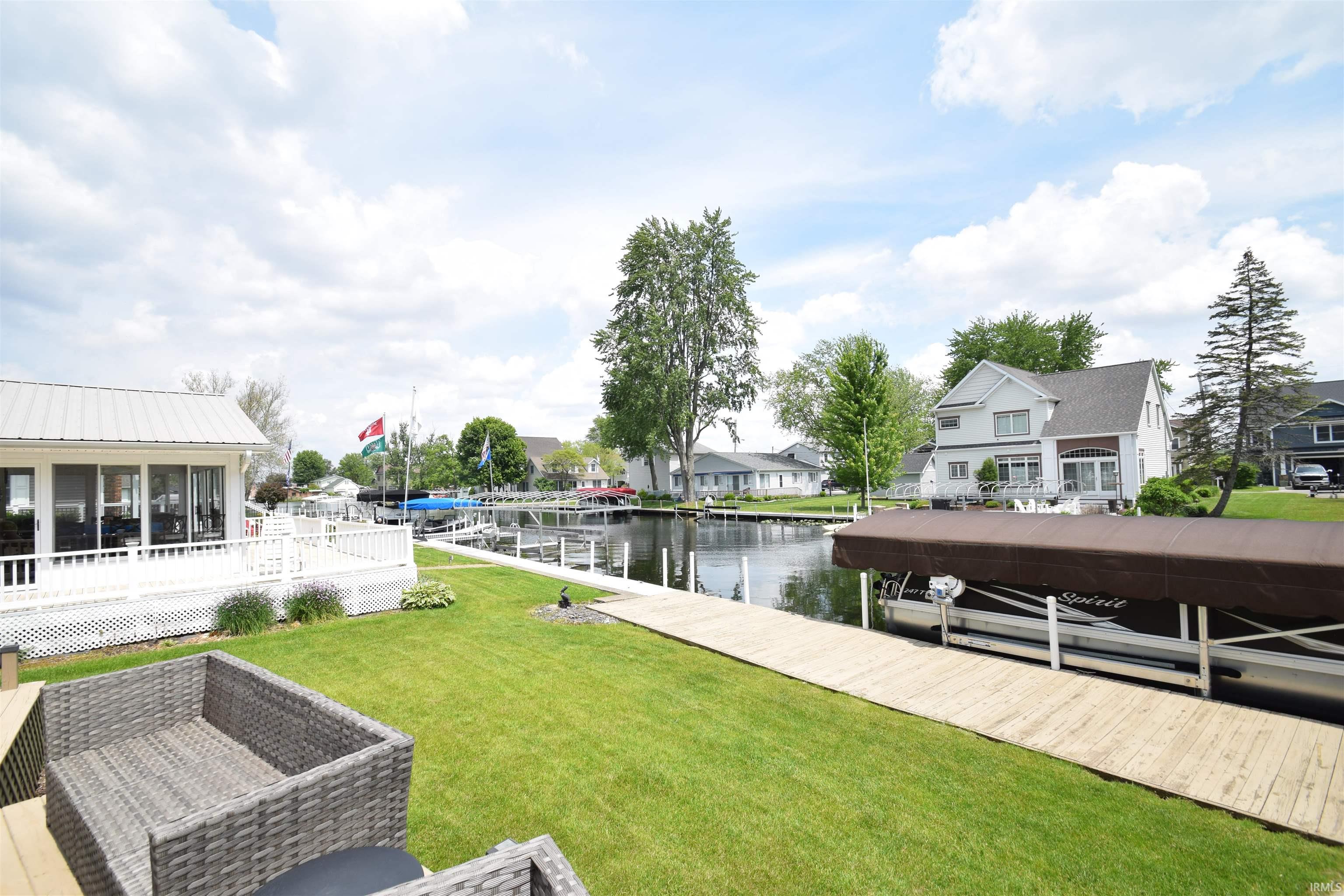 Waterfront property with a private dock featuring a boat lift