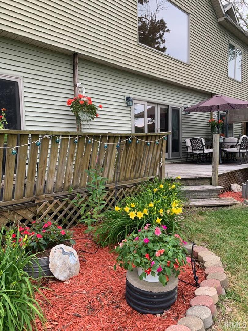 Multi-level decking with lattice accents and a dining area, featuring a sliding glass door entry to the residence