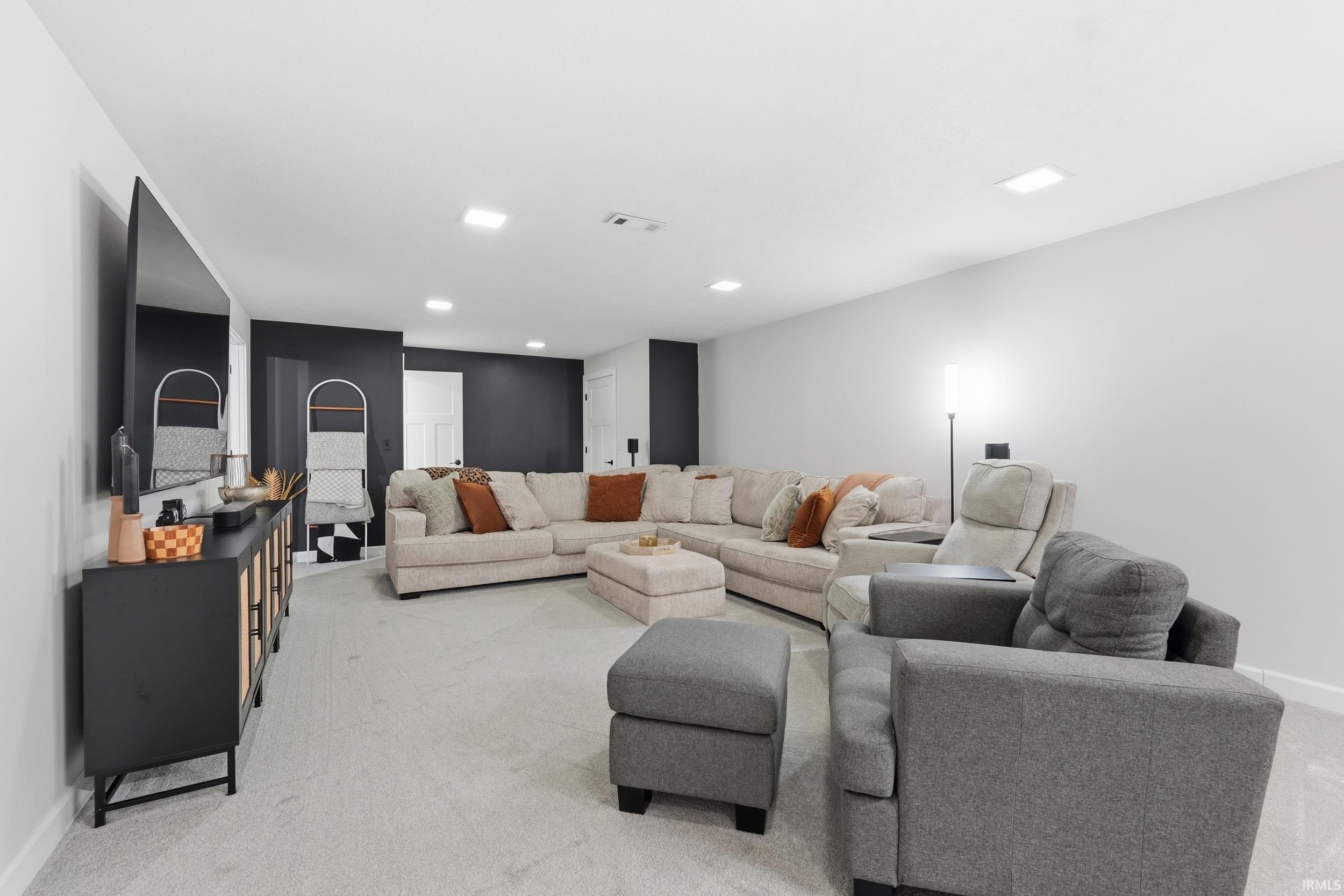 Living room featuring light colored carpet and baseboards