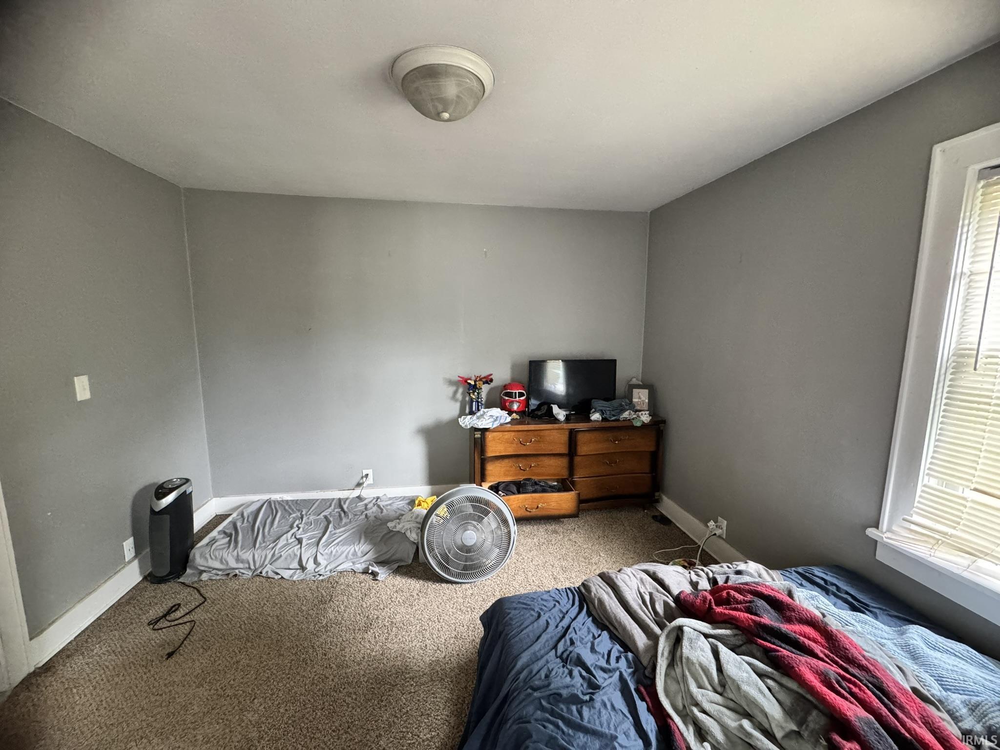 Room featuring neutral gray walls and a ceiling-mounted light fixture