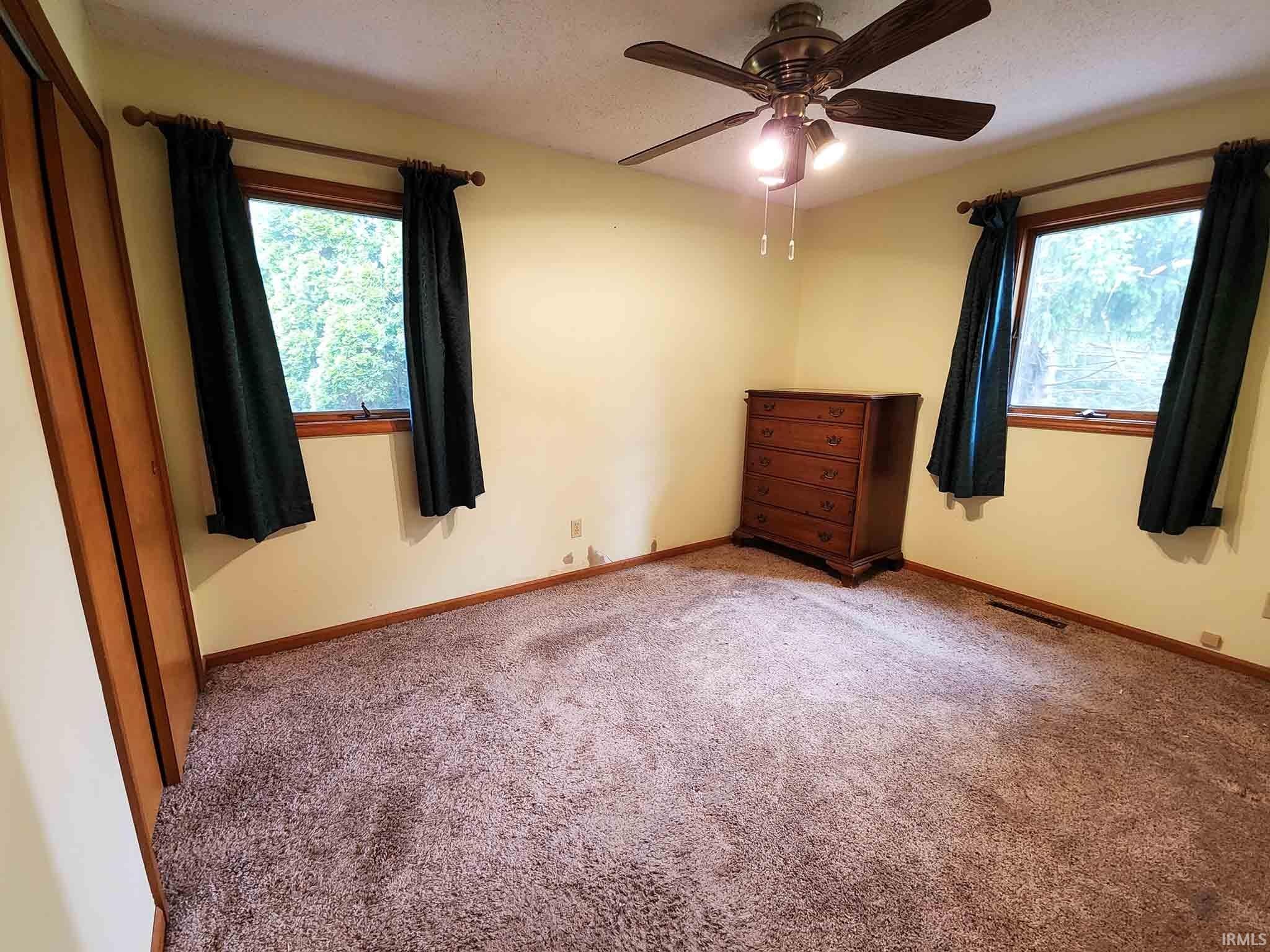 Main level bedroom with closet.