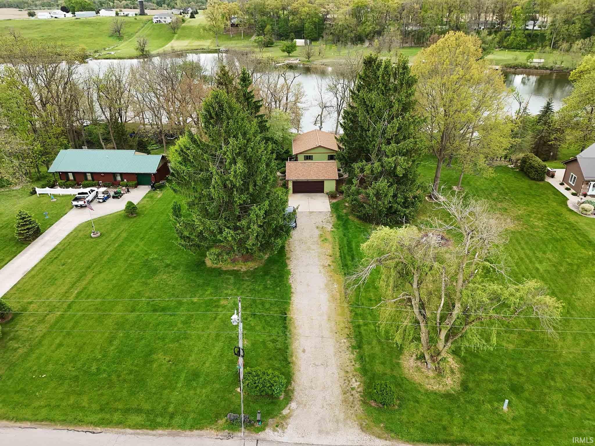 Aerial of home from street toward lake.