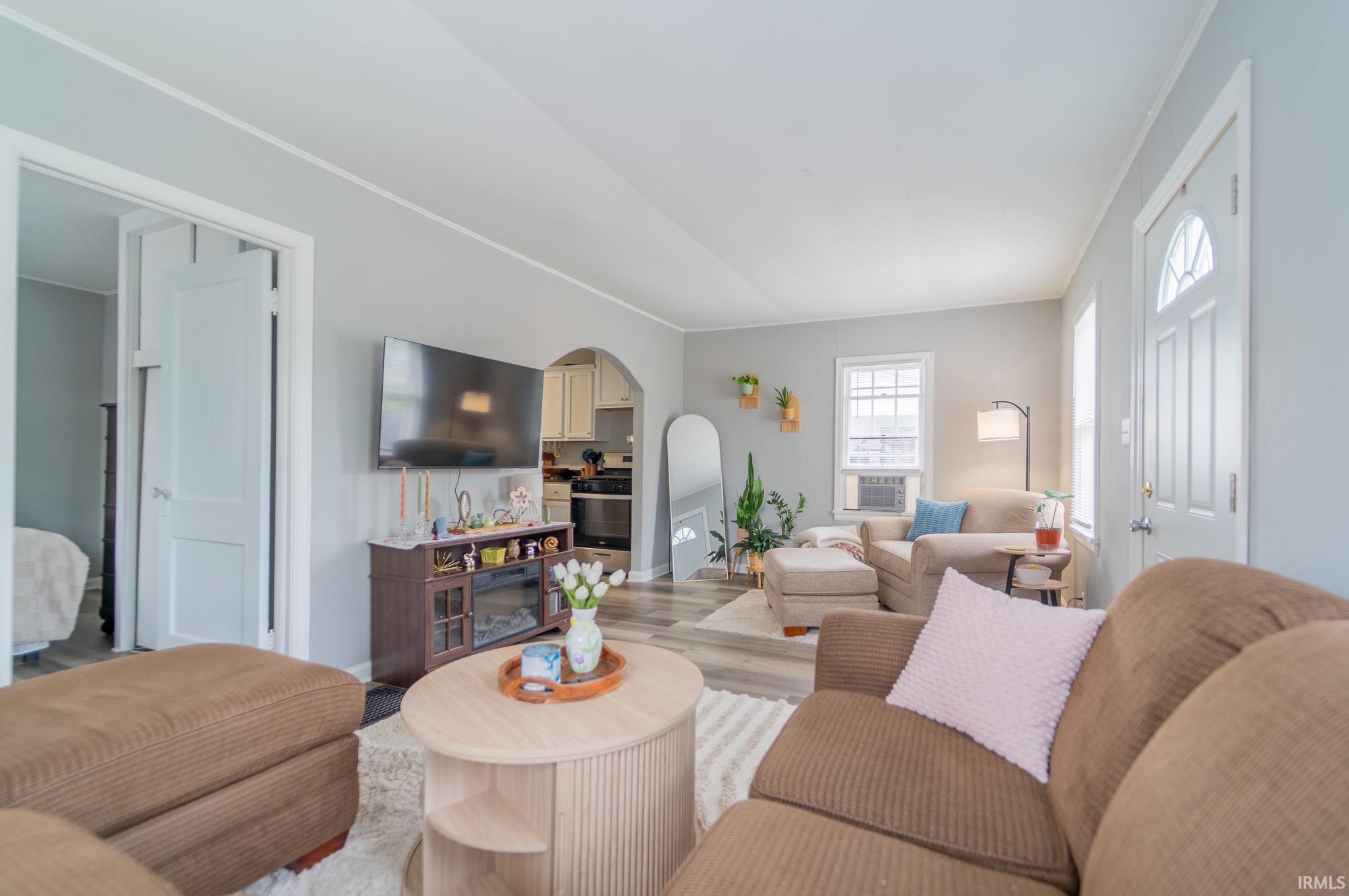 Living area featuring light gray walls and wood-finish flooring