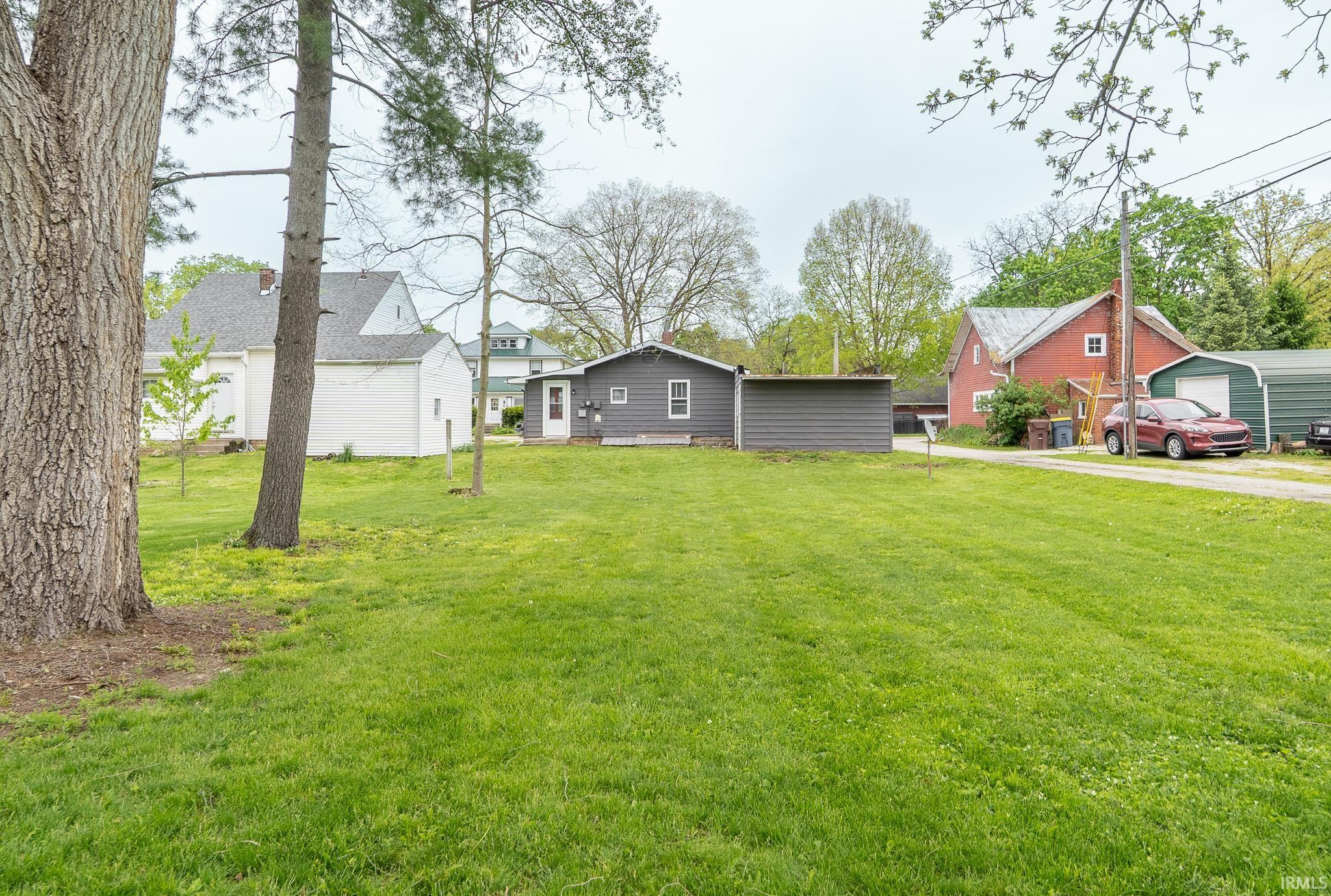 Expansive green lawn with mature trees