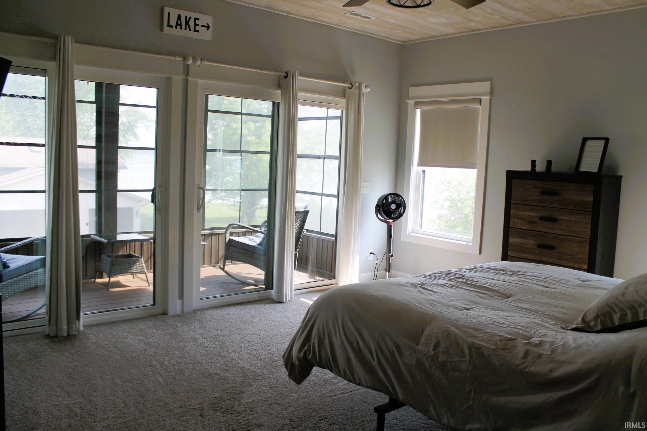 Bright room featuring multiple glass sliding doors opening to an exterior deck