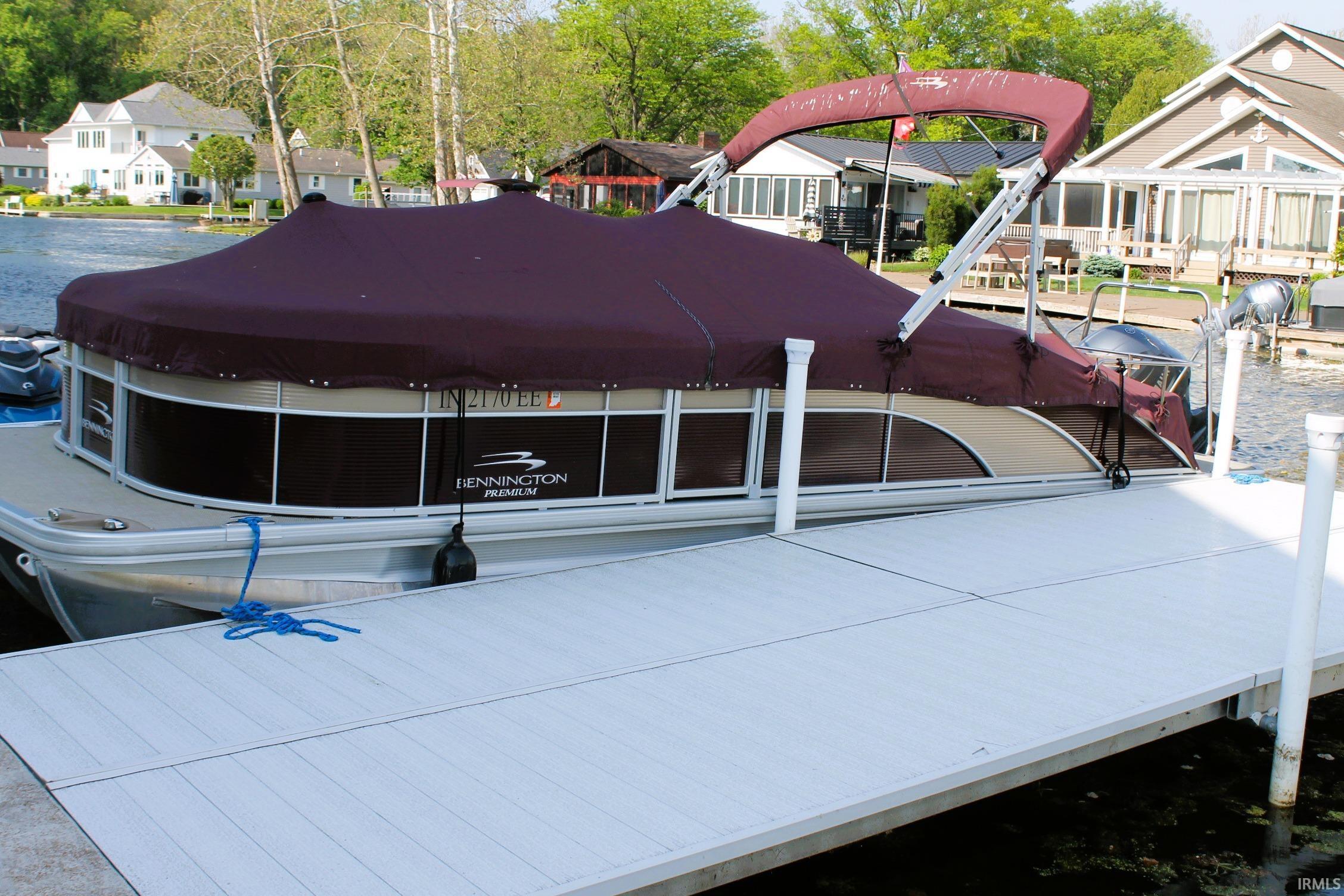 Private white pier extending over water, providing direct water access