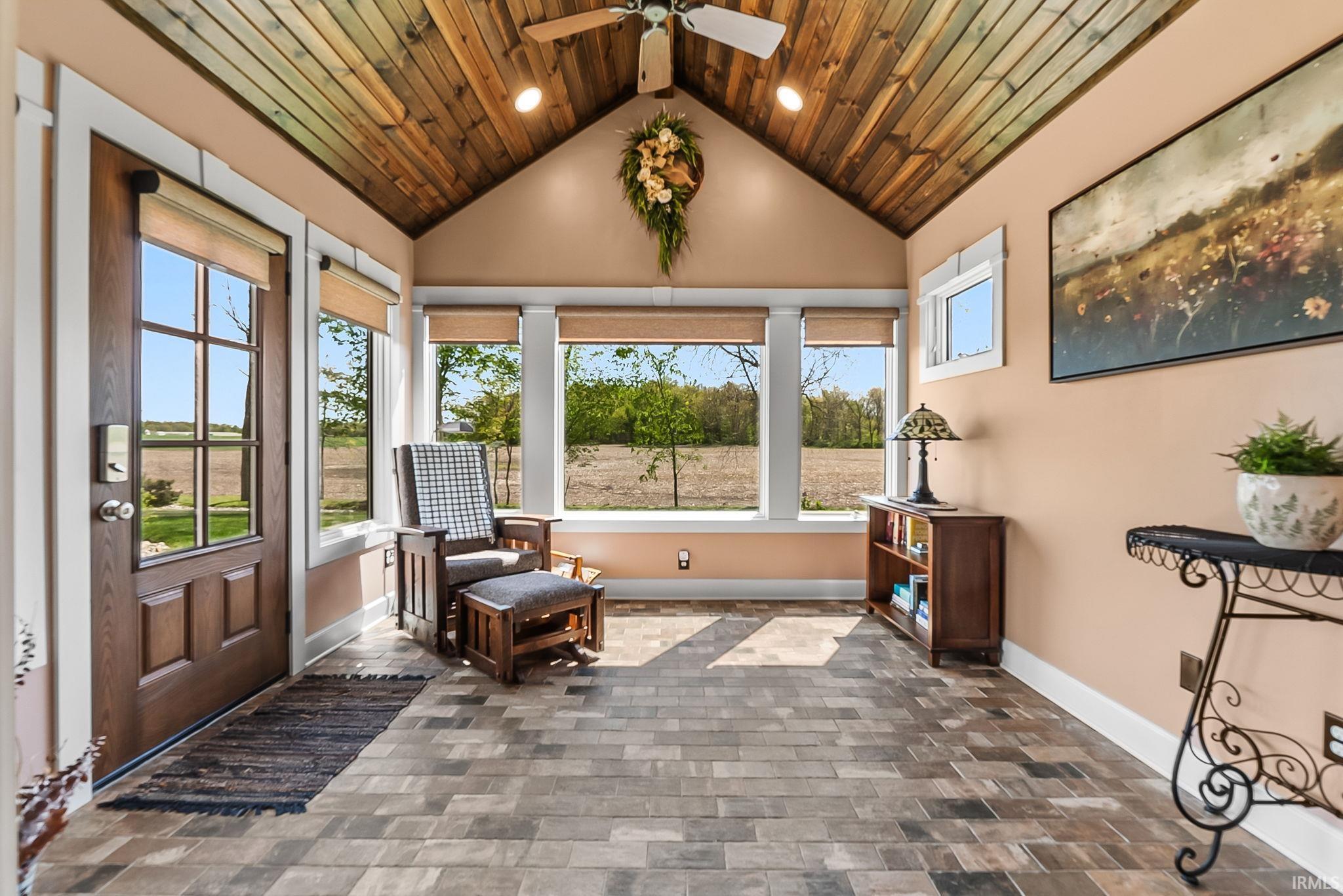 Vaulted wood-plank ceiling with recessed lighting and ceiling fan