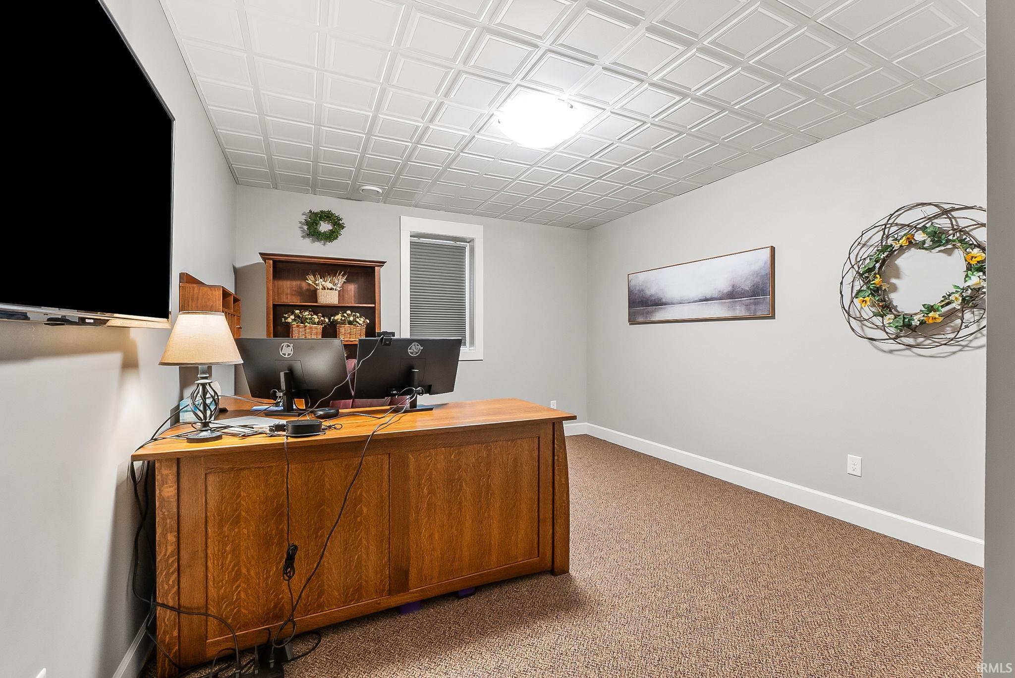 Room featuring a textured ceiling, neutral wall paint, and a built-in window