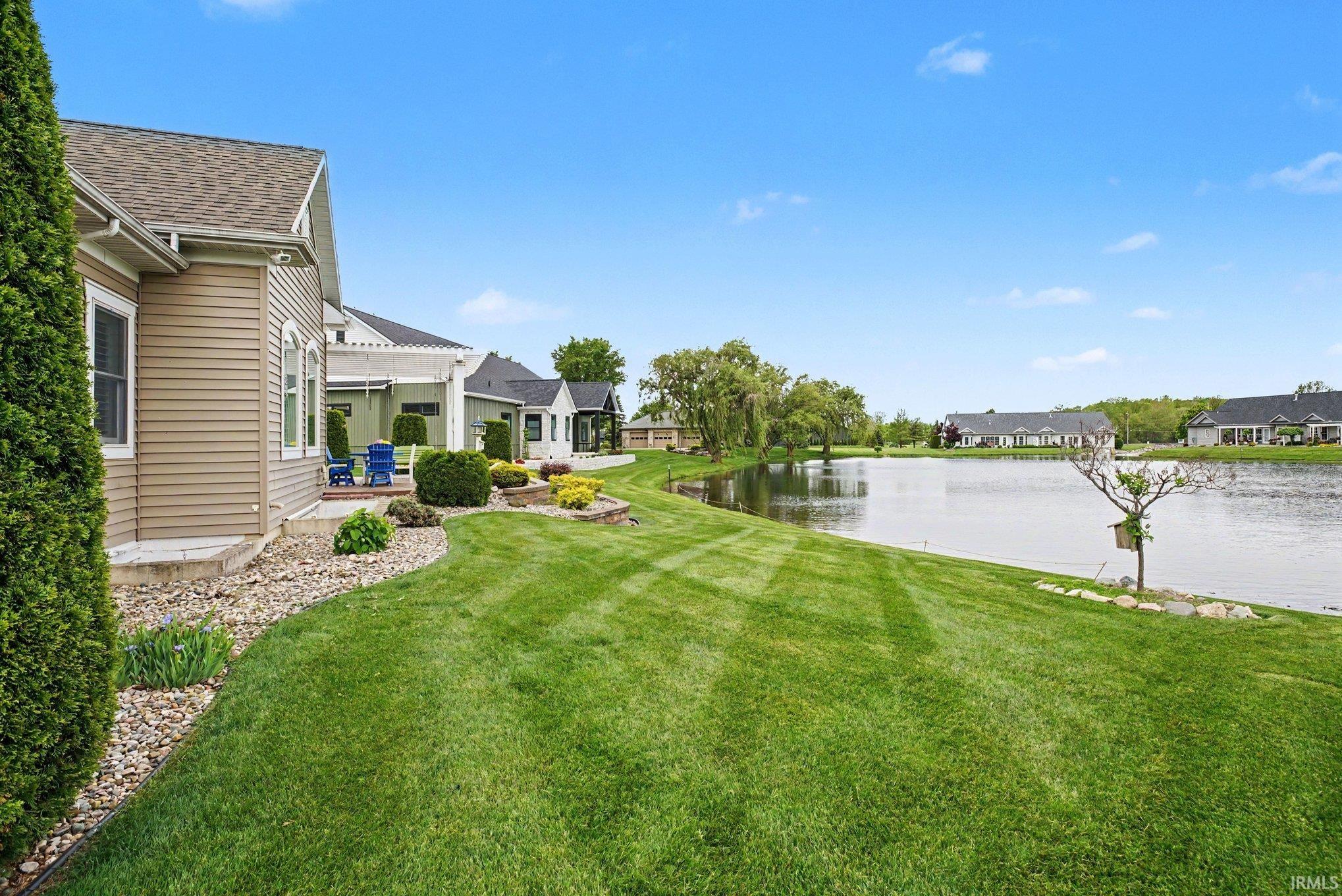 Manicured lawn extending to a substantial body of water