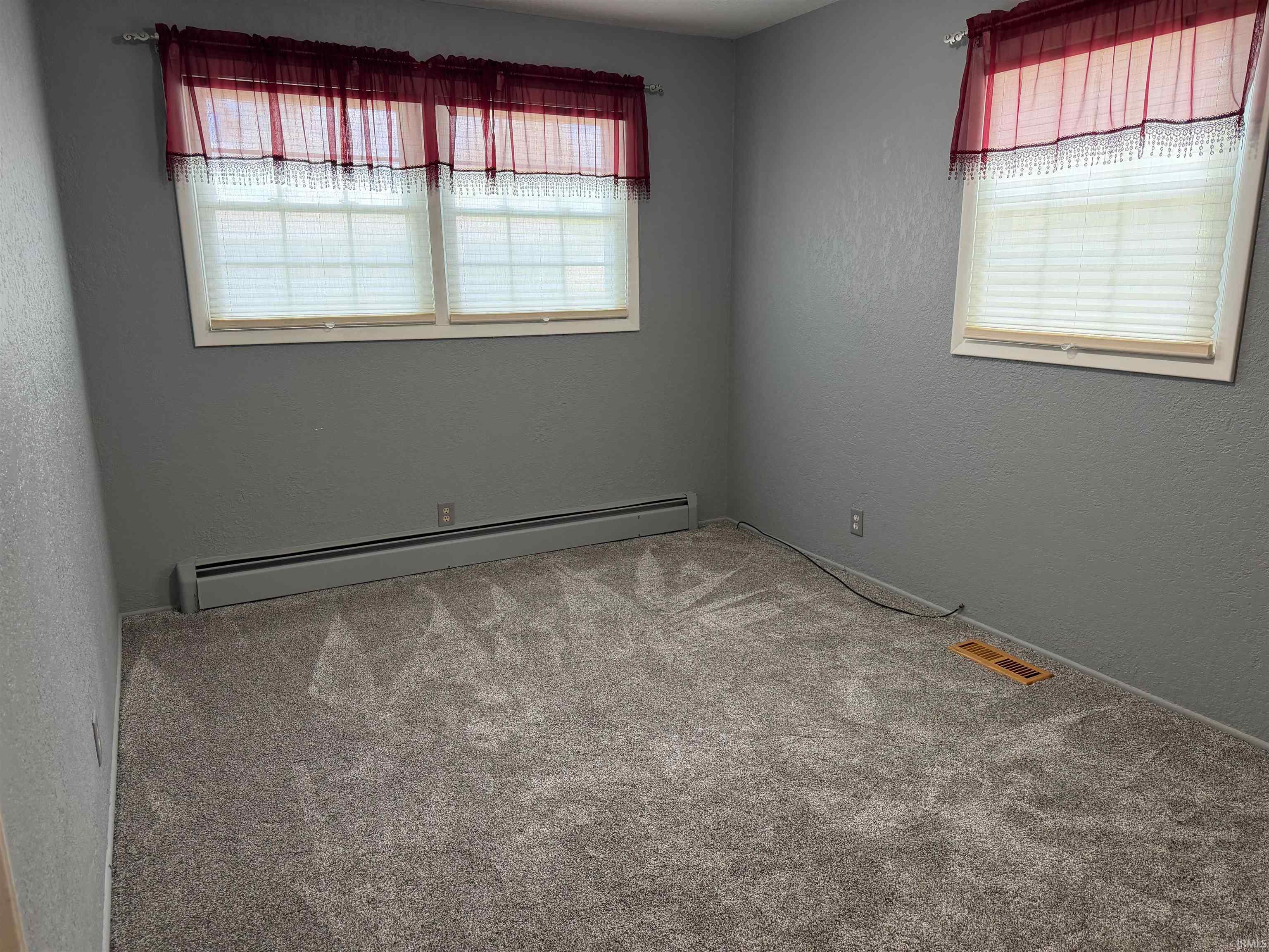 Carpeted room with multiple windows