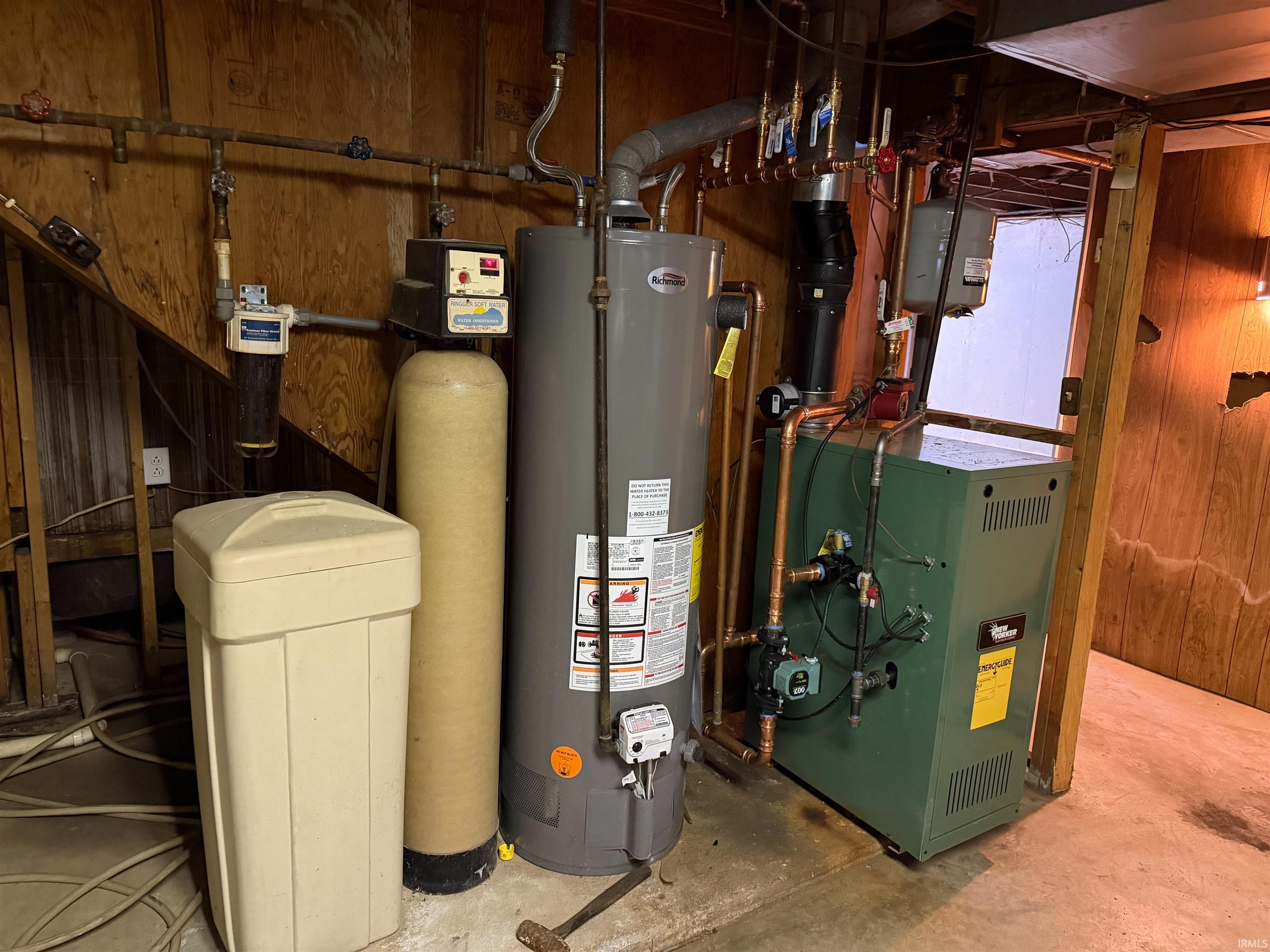 Utility area featuring a water heater, water softener system, water filtration unit, and boiler
