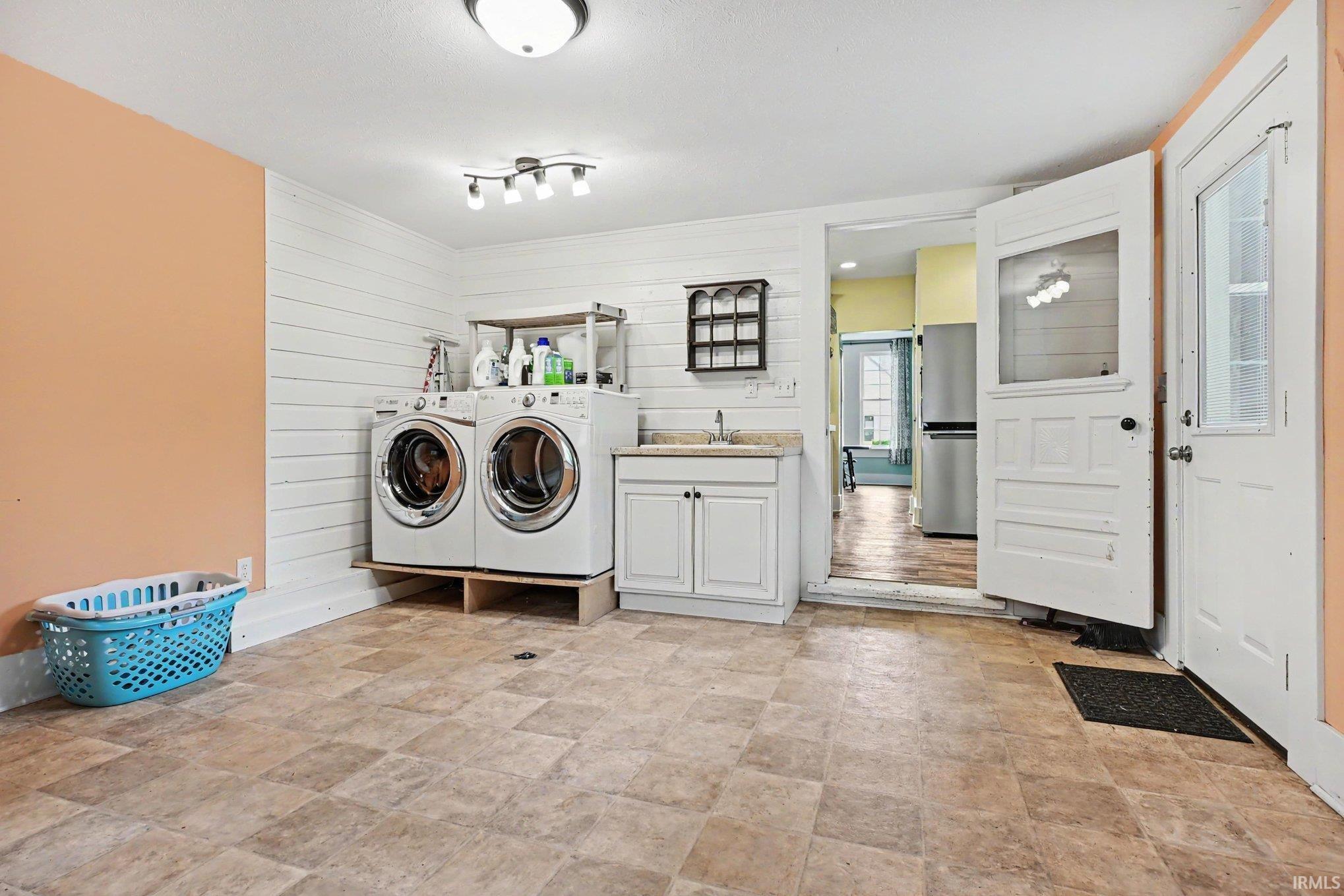 Spacious mudroom/laundry room combo, located in from the back door, just off of the kitchen.