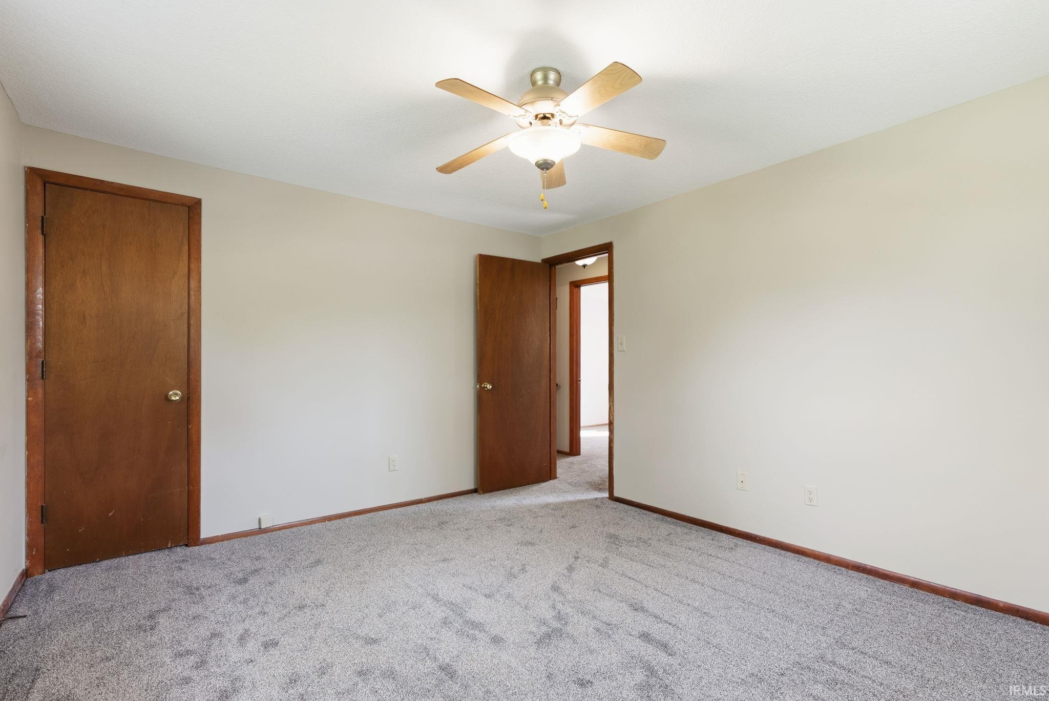 Carpeted interior space with light-toned walls