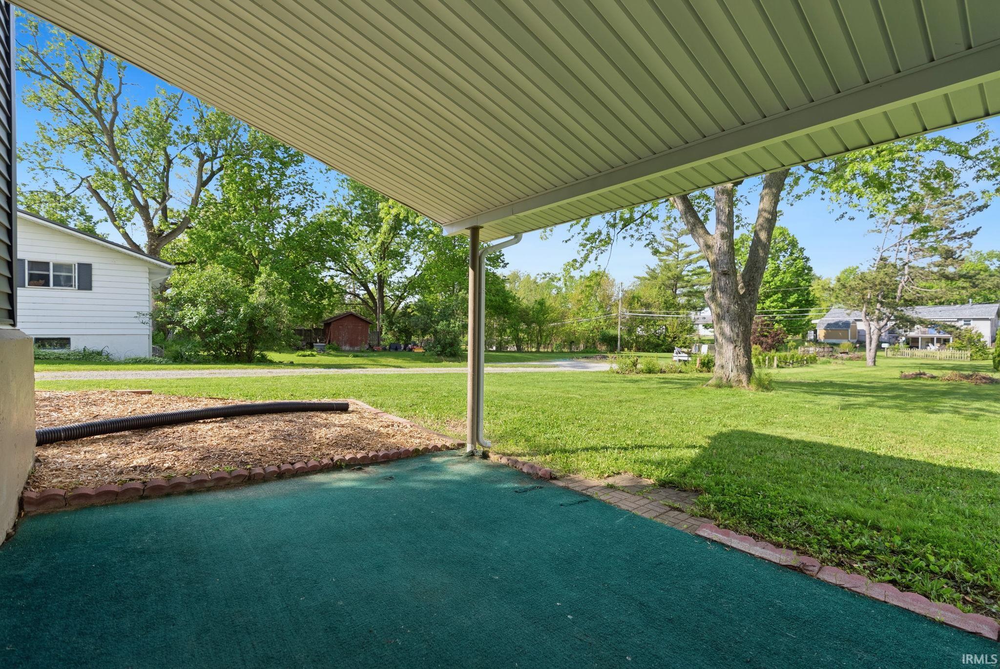 Covered patio with green outdoor carpeting