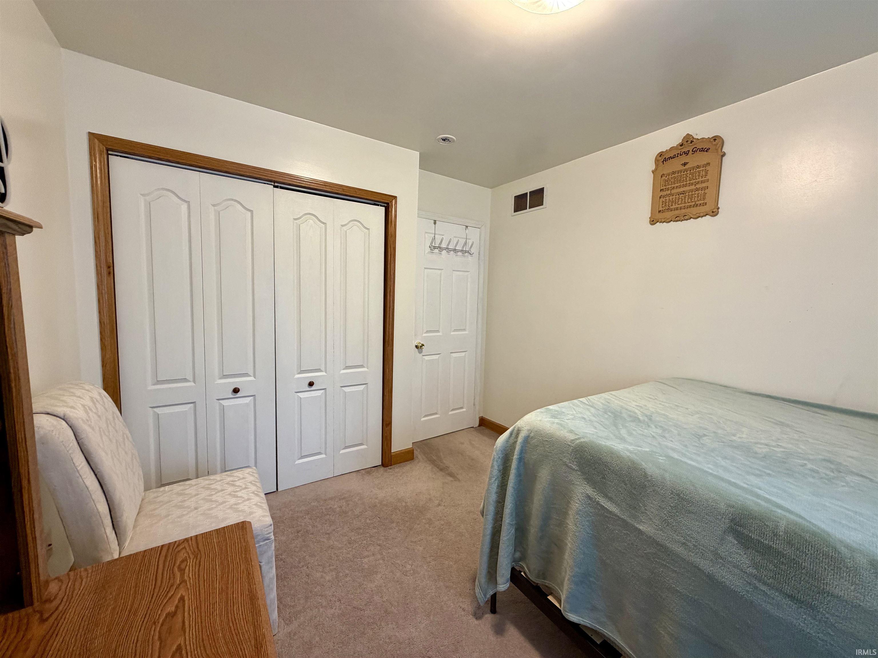 Bedroom featuring neutral-toned carpeting and white walls