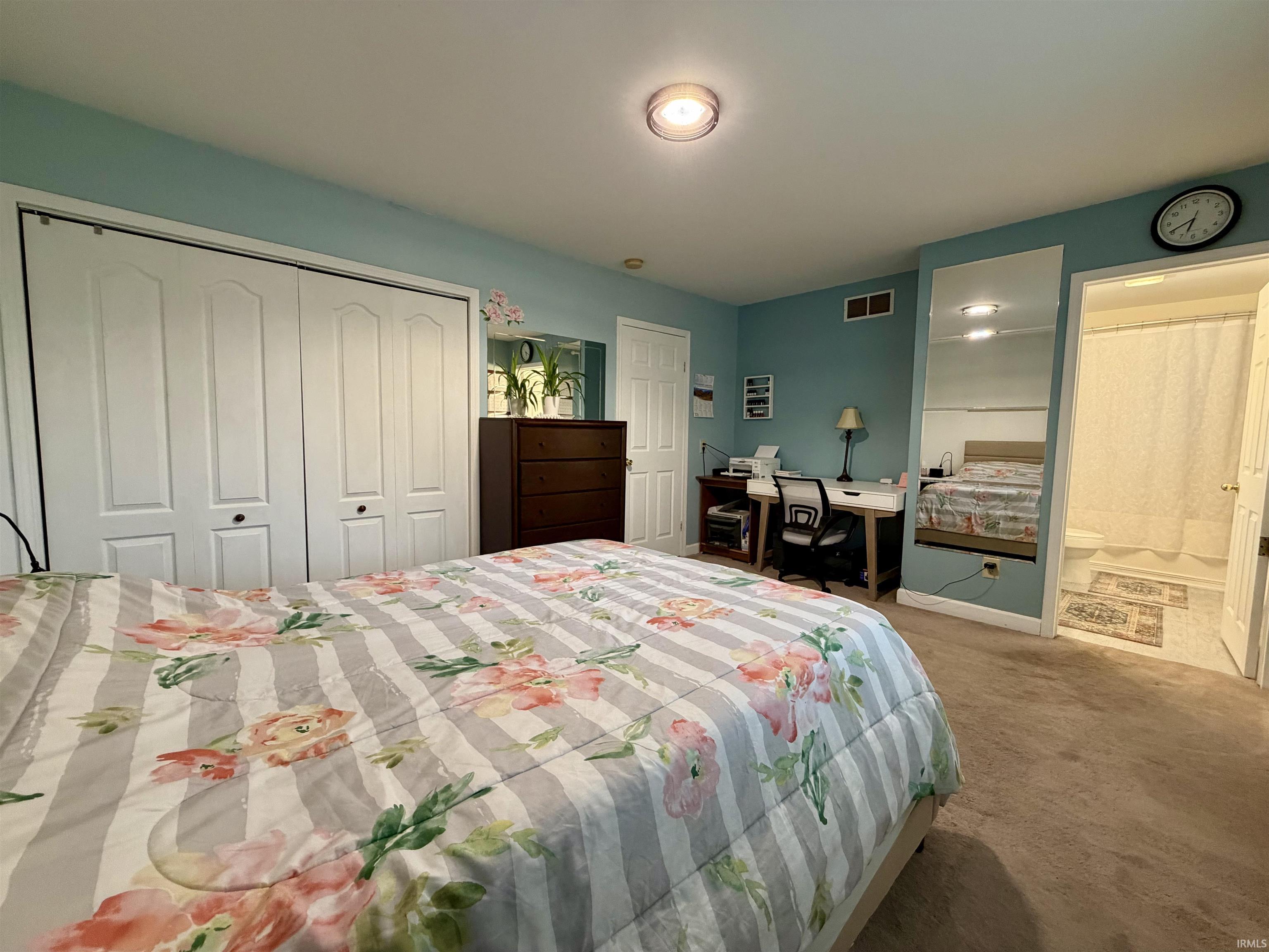 Bedroom featuring light blue walls and brown carpet flooring