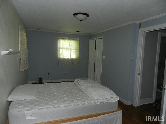 Wood-finish flooring with light blue wall paint and white trim molding