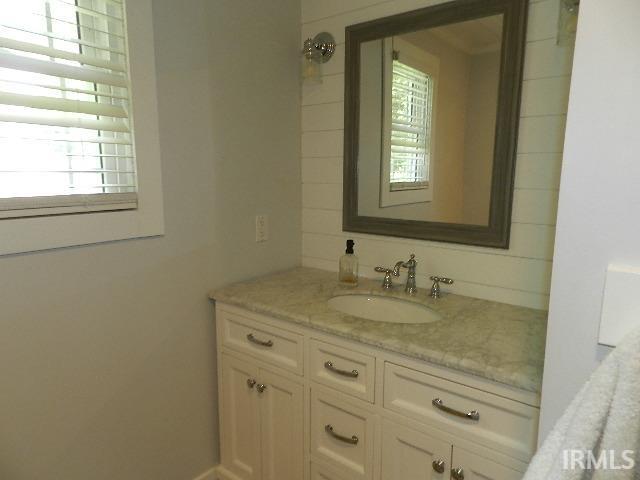 Vanity featuring a built-in sink, polished chrome fixtures, and a light-toned countertop