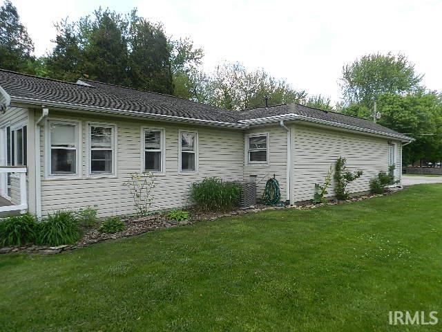 Exterior siding with multiple windows and a pitched roof