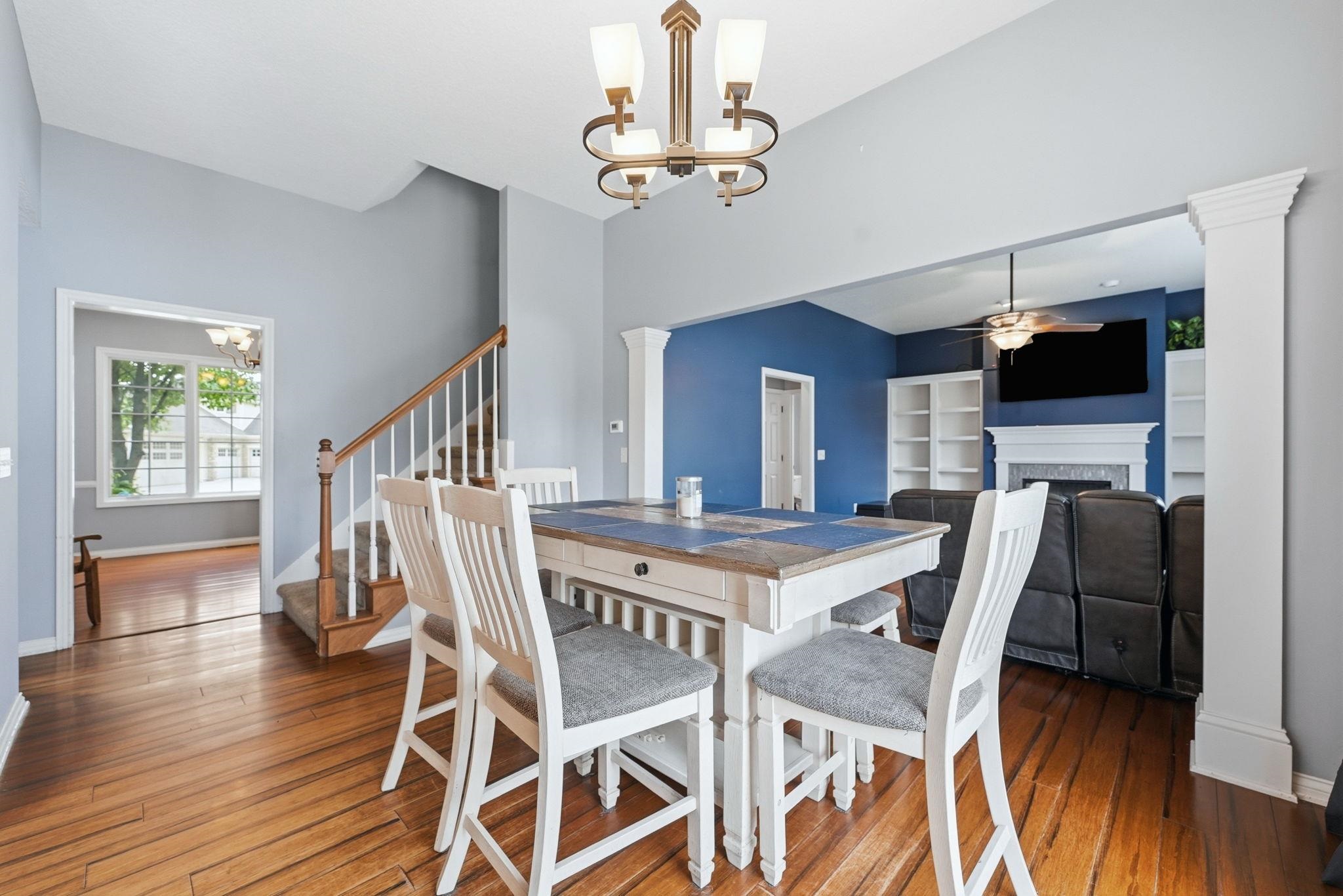 Open-concept living area with hardwood flooring and light blue walls