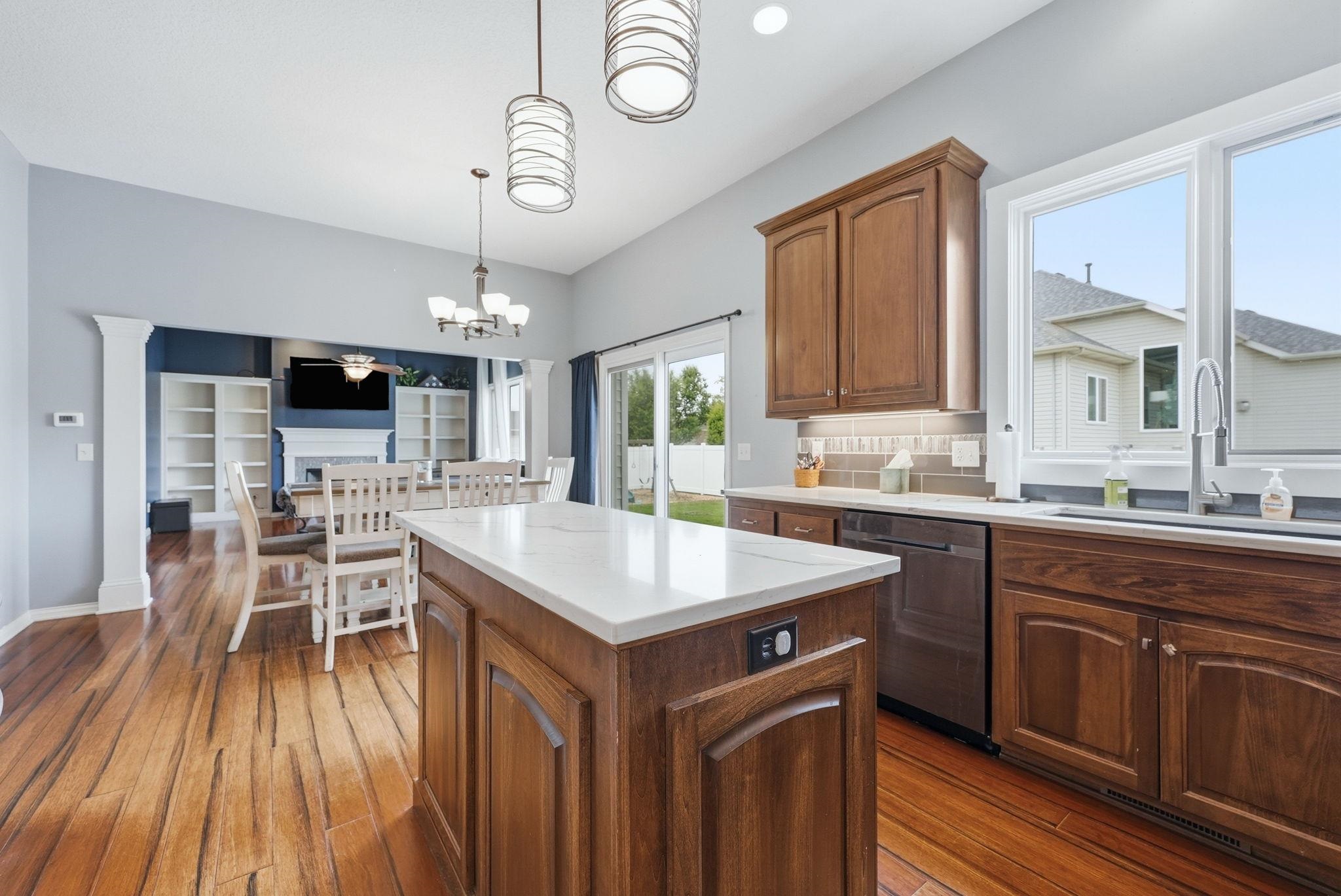 Kitchen island with white countertop and wood-finish cabinetry
