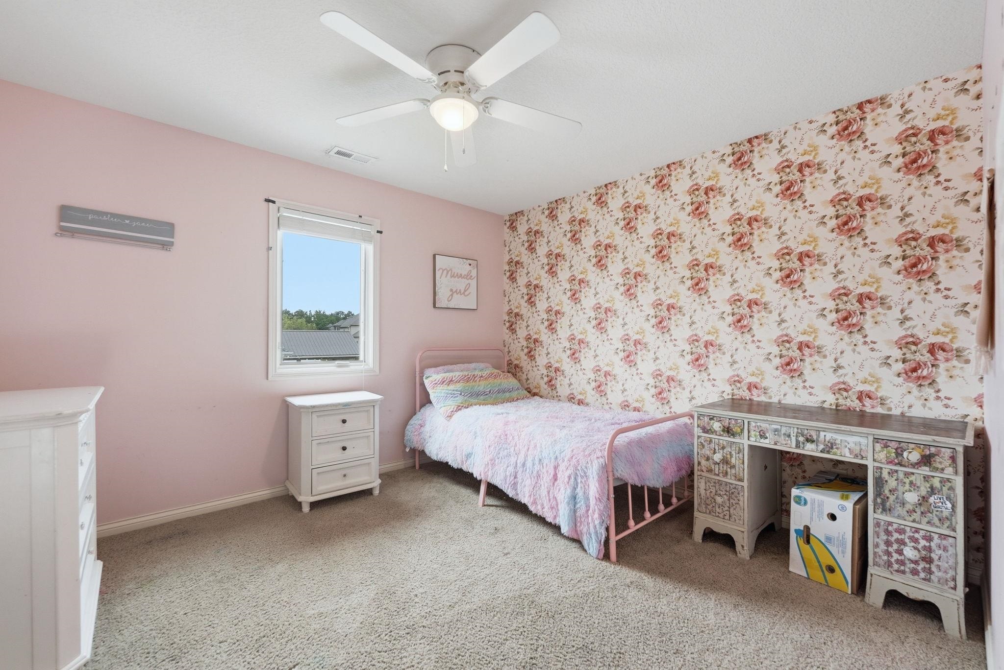Room featuring a single window, a ceiling fan with integrated lighting, and carpet flooring