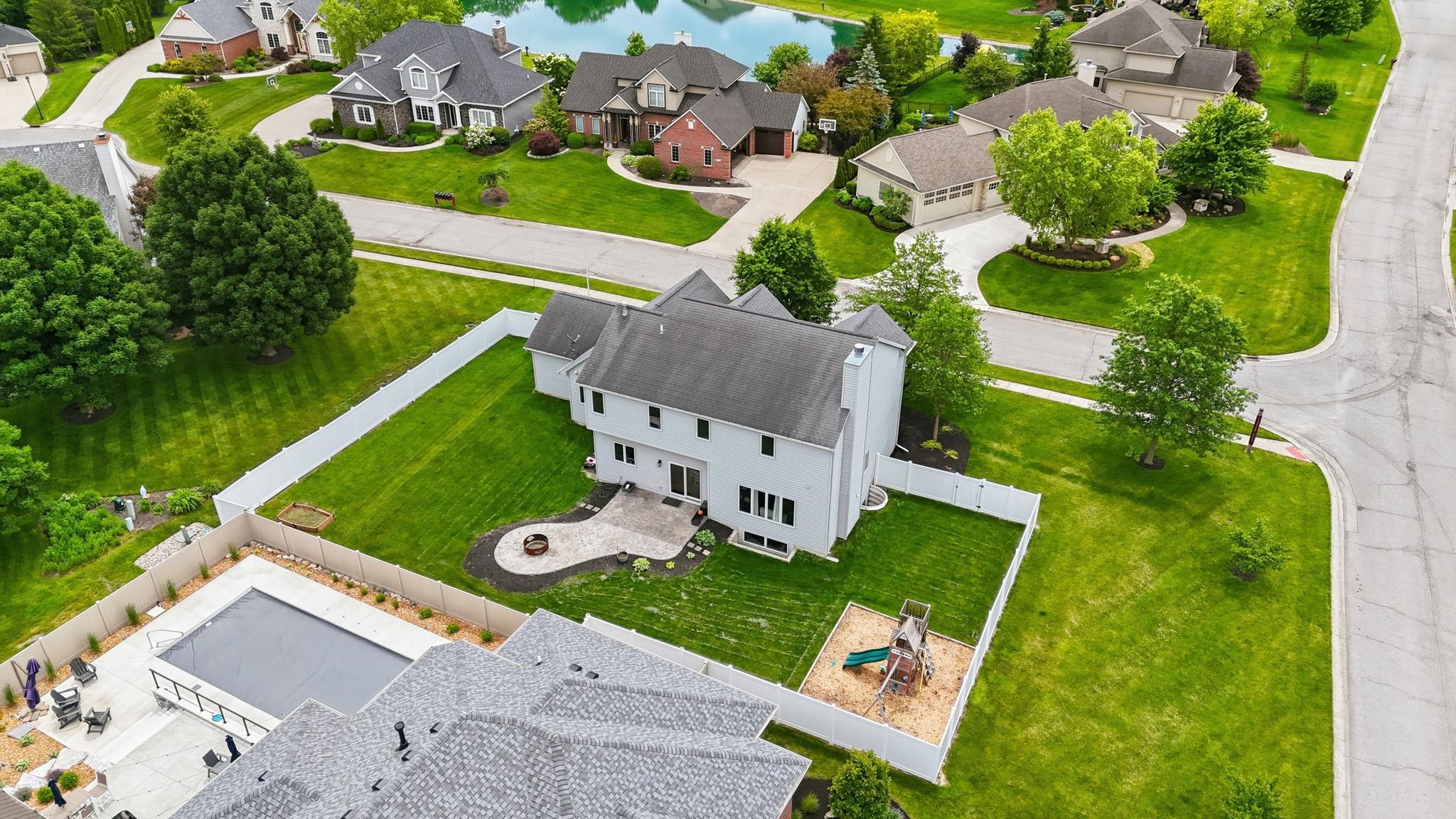 Two-story residence with a white exterior and a gray gabled roof