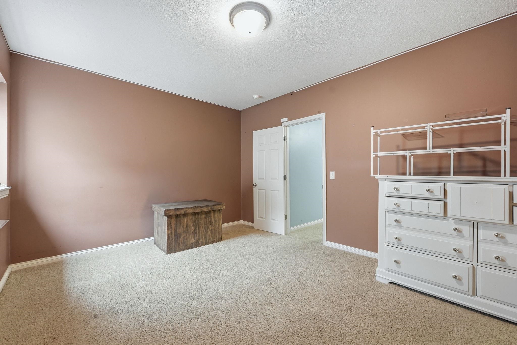 Carpeted interior space featuring neutral wall tones