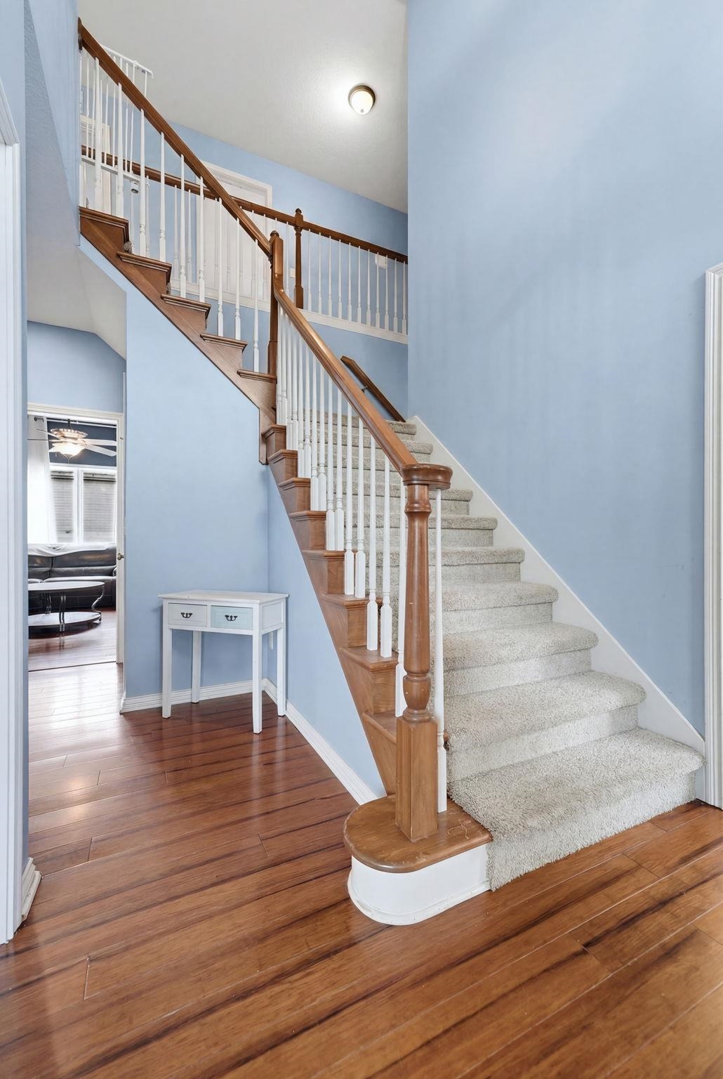 Inviting entryway with rich wood-finish flooring