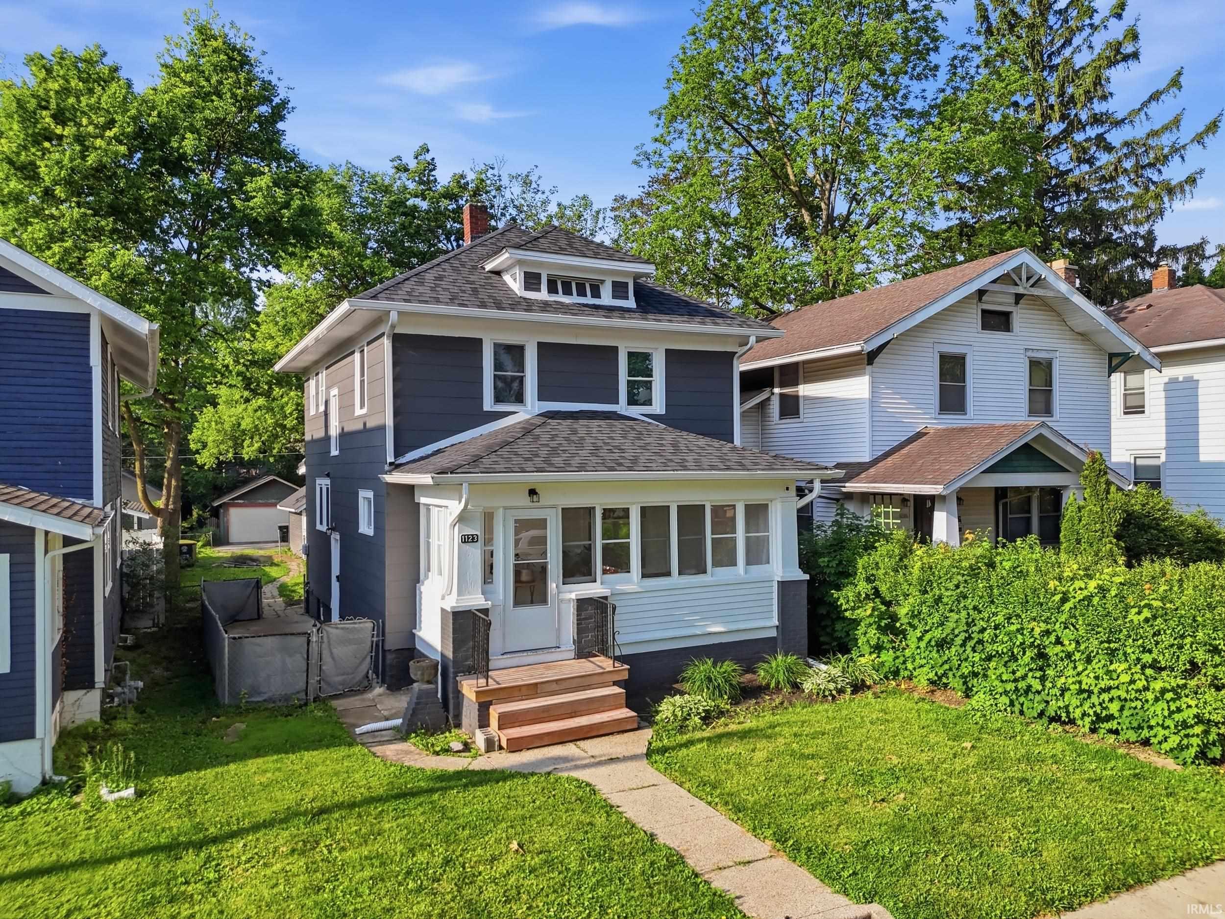 Two-story residence featuring contemporary dark gray siding and white trim