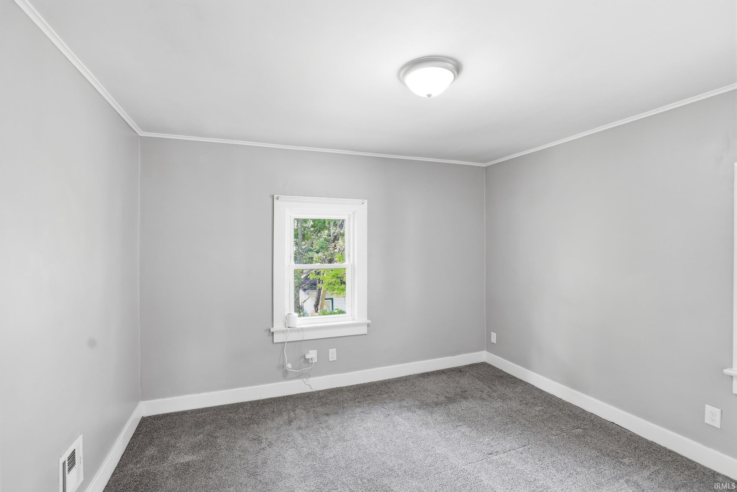 Neutral grey walls with contrasting white trim and crown molding