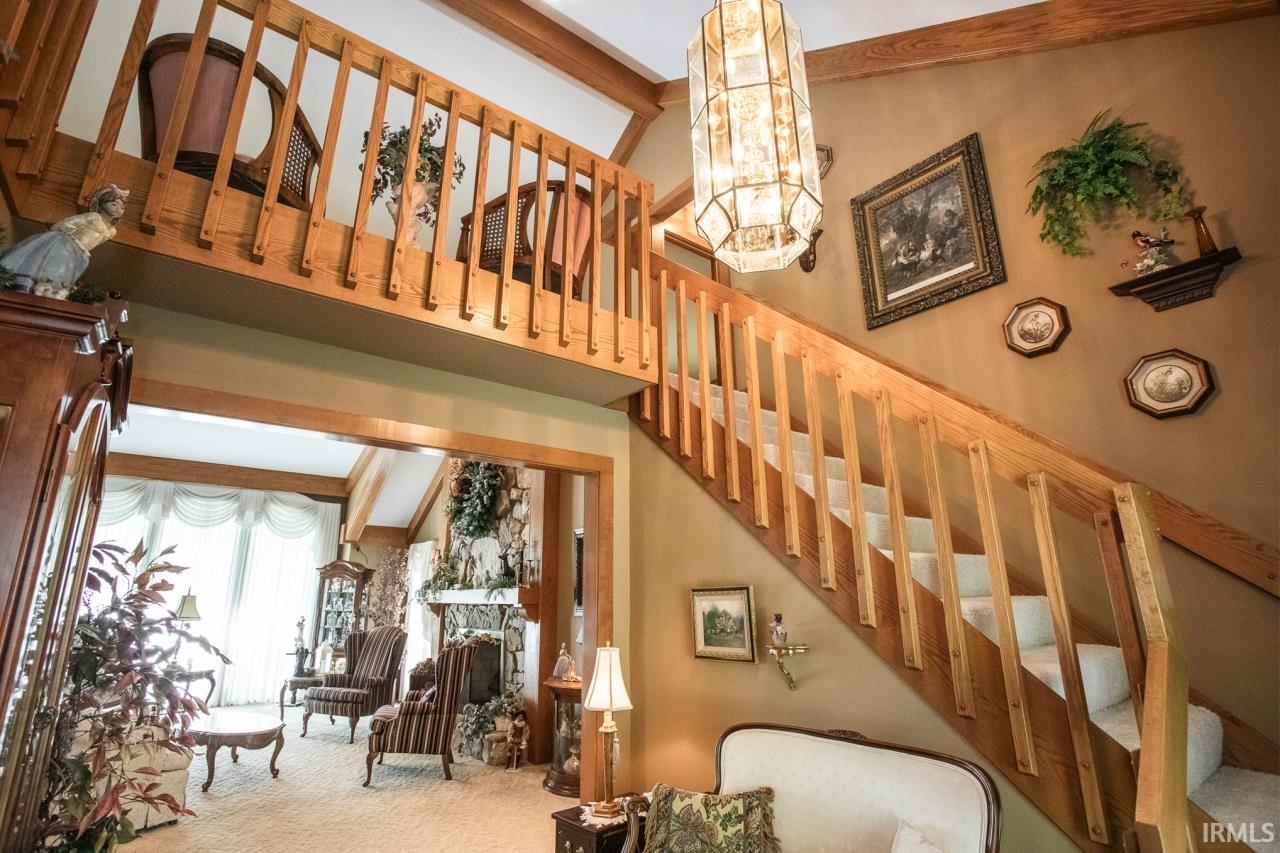 Open-concept interior featuring a double-height ceiling and exposed wood beams