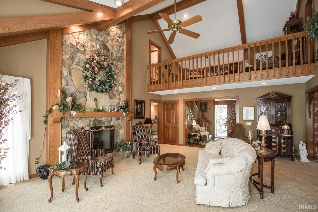 Vaulted ceiling featuring exposed wood beams and recessed lighting