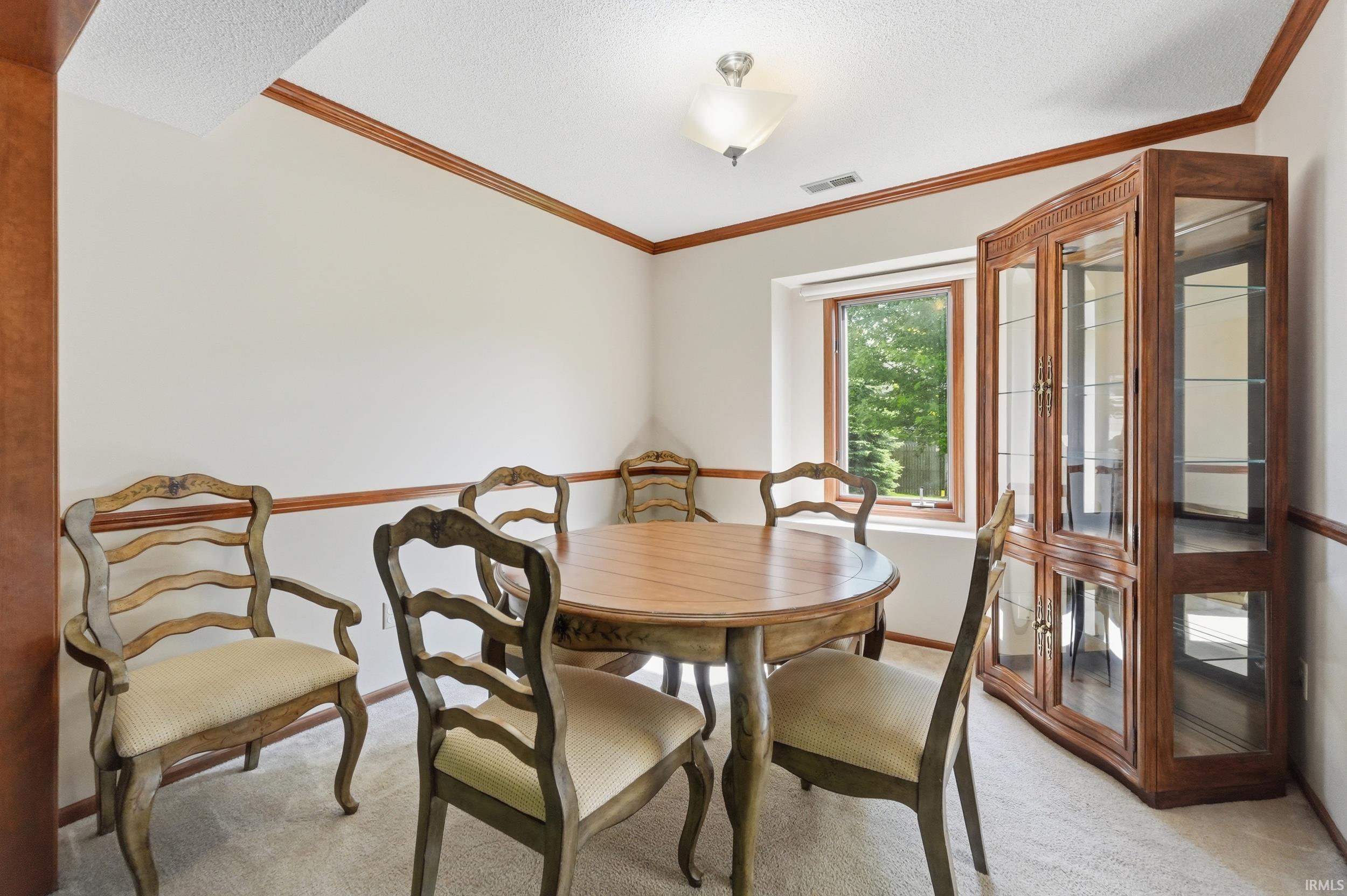 Carpeted room featuring a single window, white walls, and wood trim