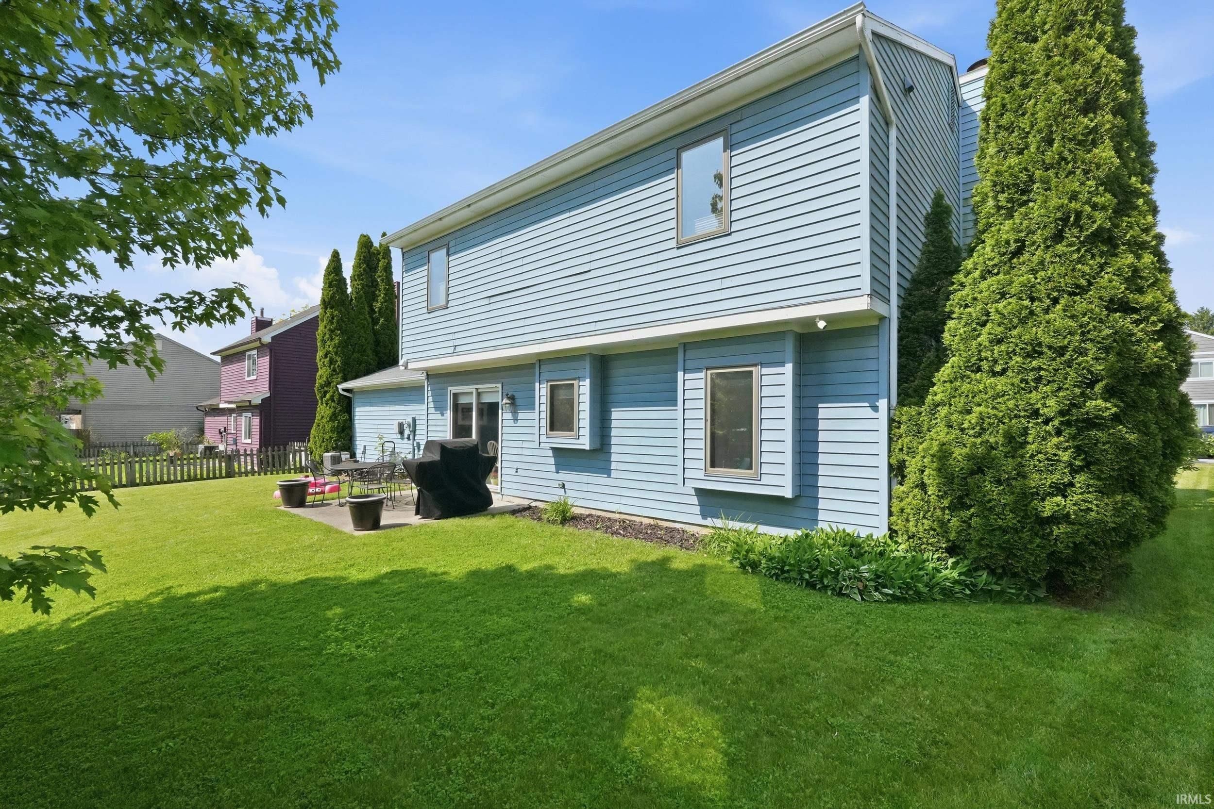 Expansive green lawn with a patio area