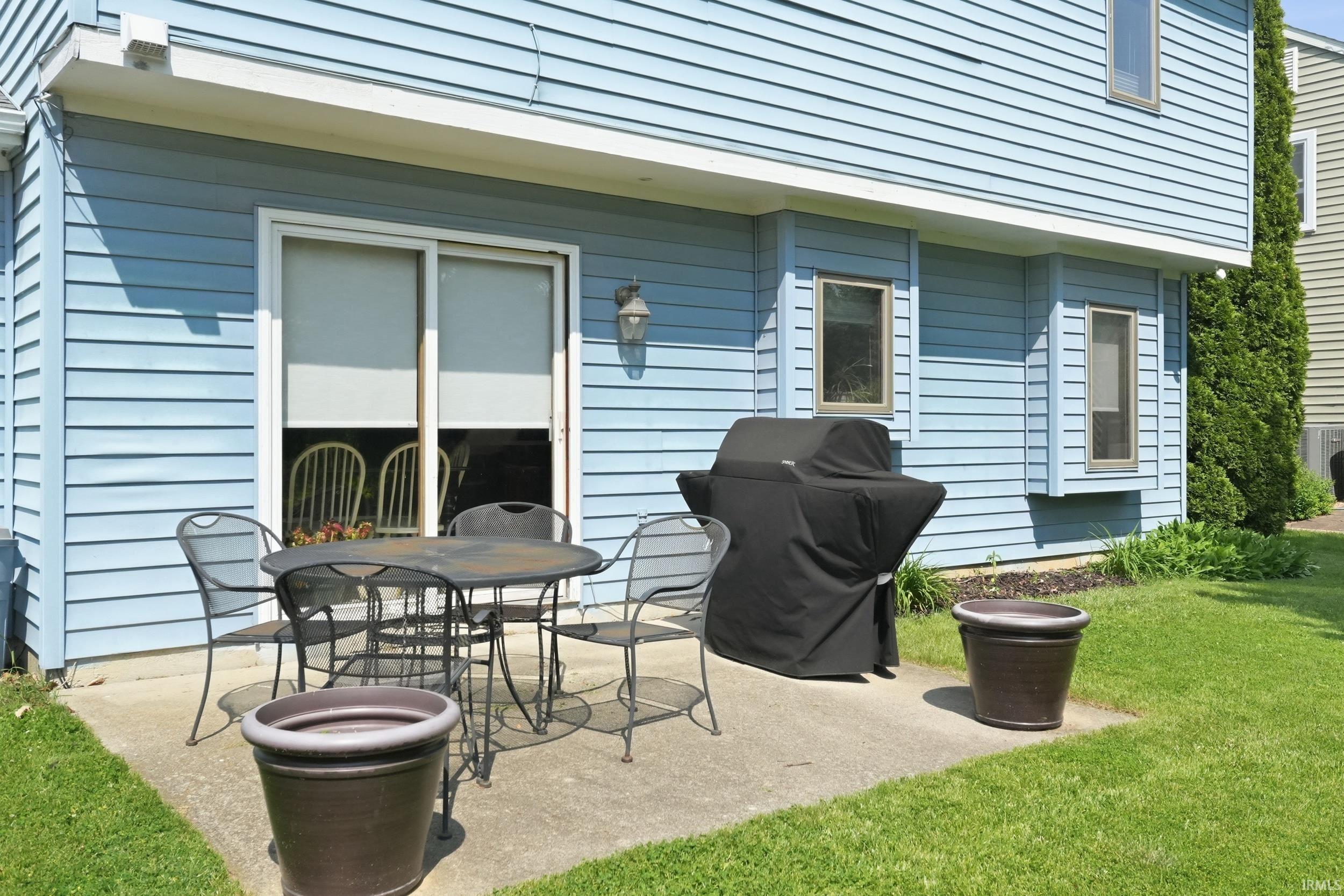 Concrete patio with light blue horizontal siding