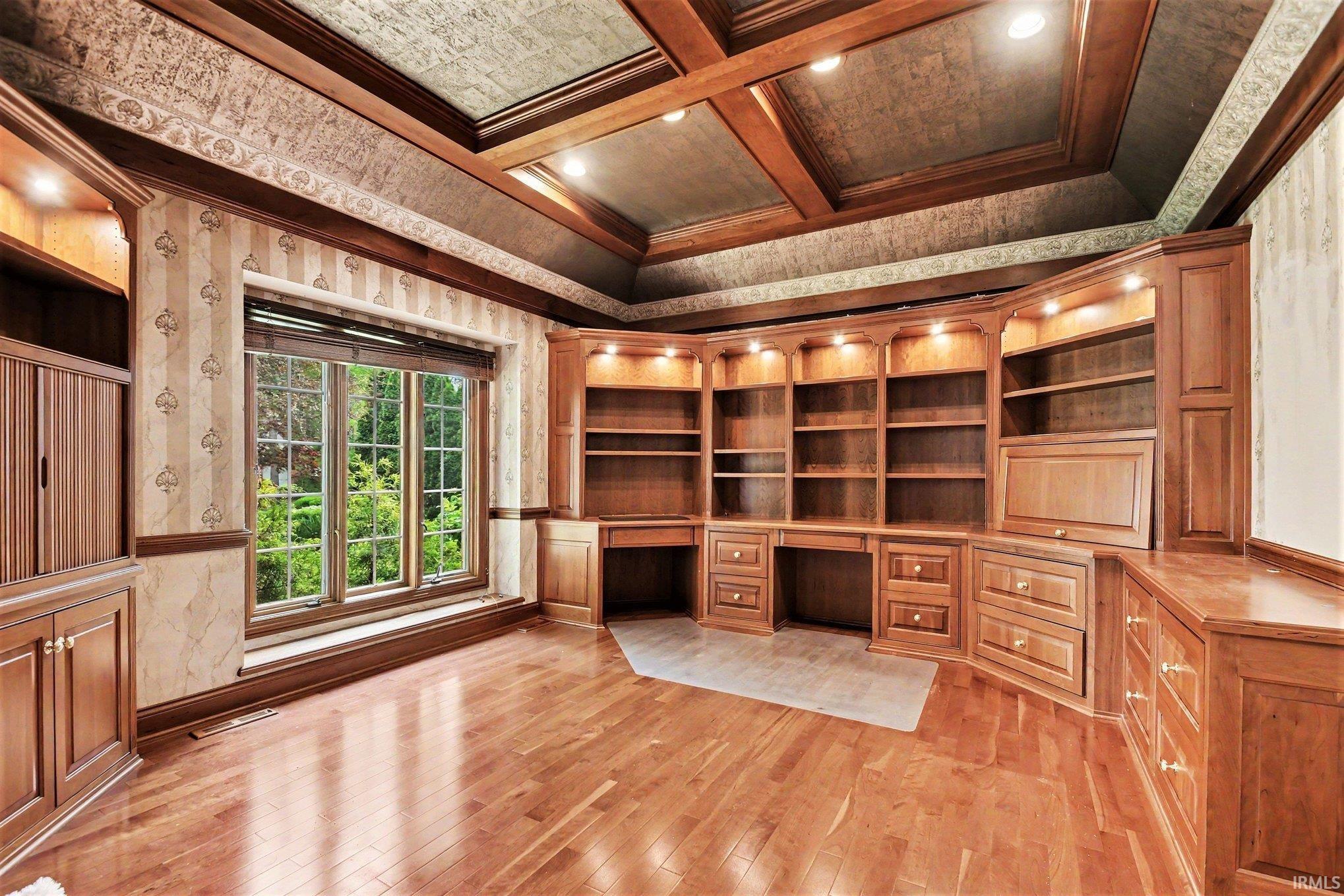 Custom built-in wood cabinetry with integrated shelving and task lighting