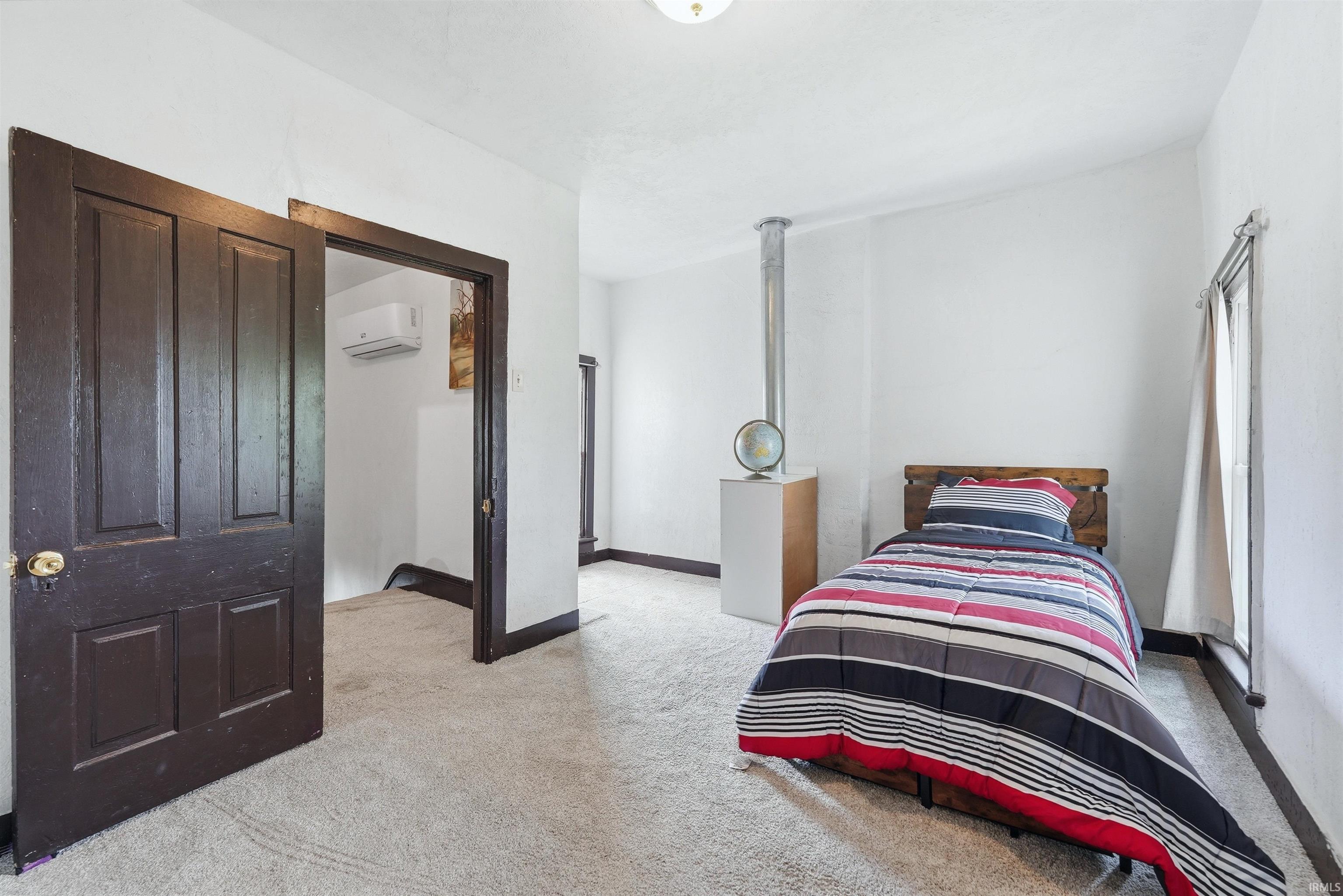 Carpeted room with white walls and dark trim